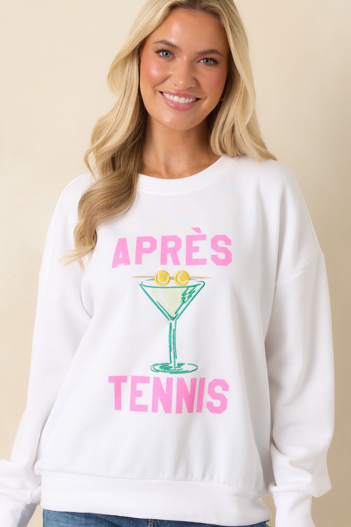 Closer view of the front design showcasing the embroidered martini glass with tennis ball details and bold pink typography.