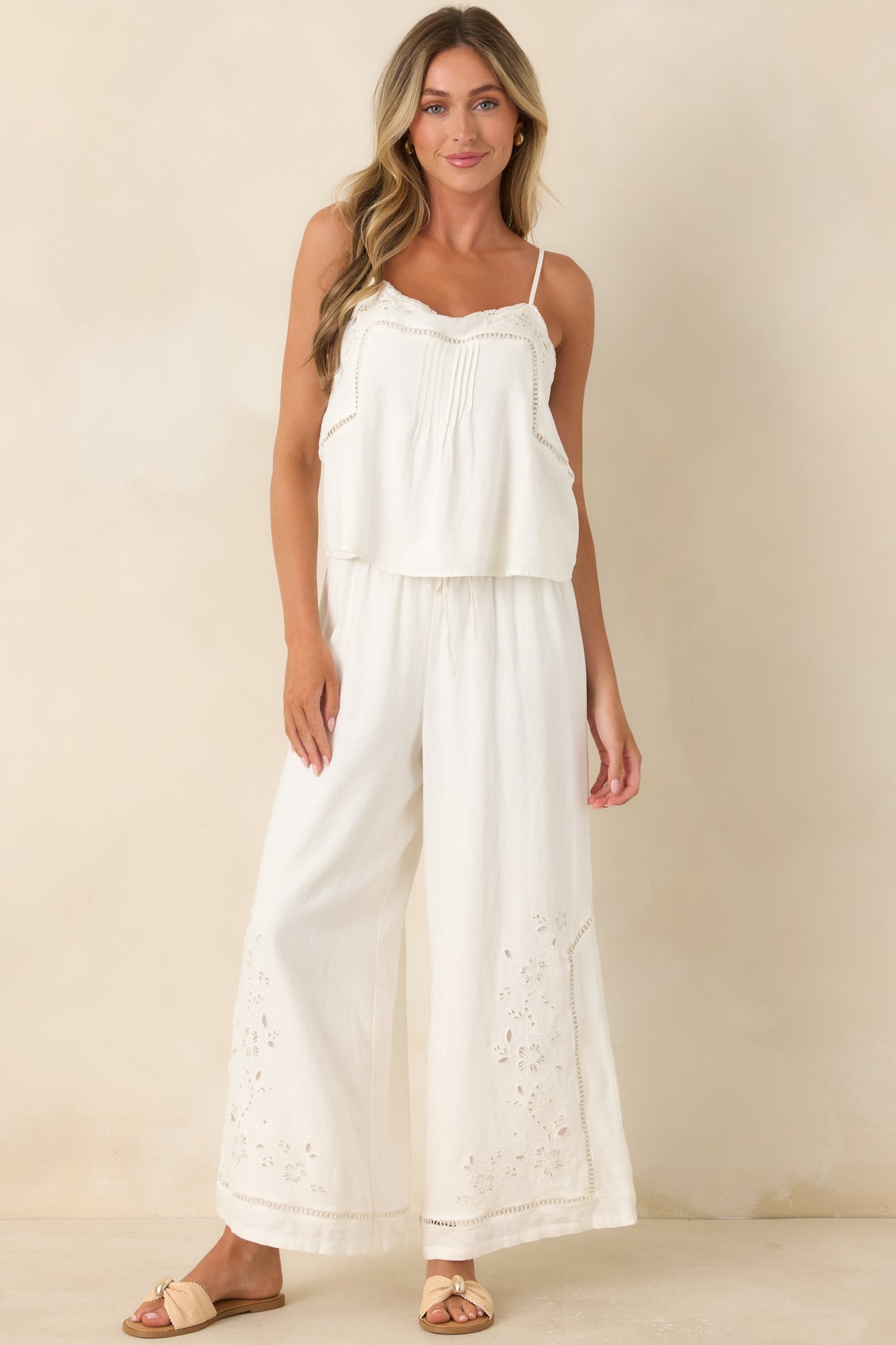 Embroidered sleeveless top with pintuck detailing, delicate lace edging, and a lightweight linen and rayon construction.