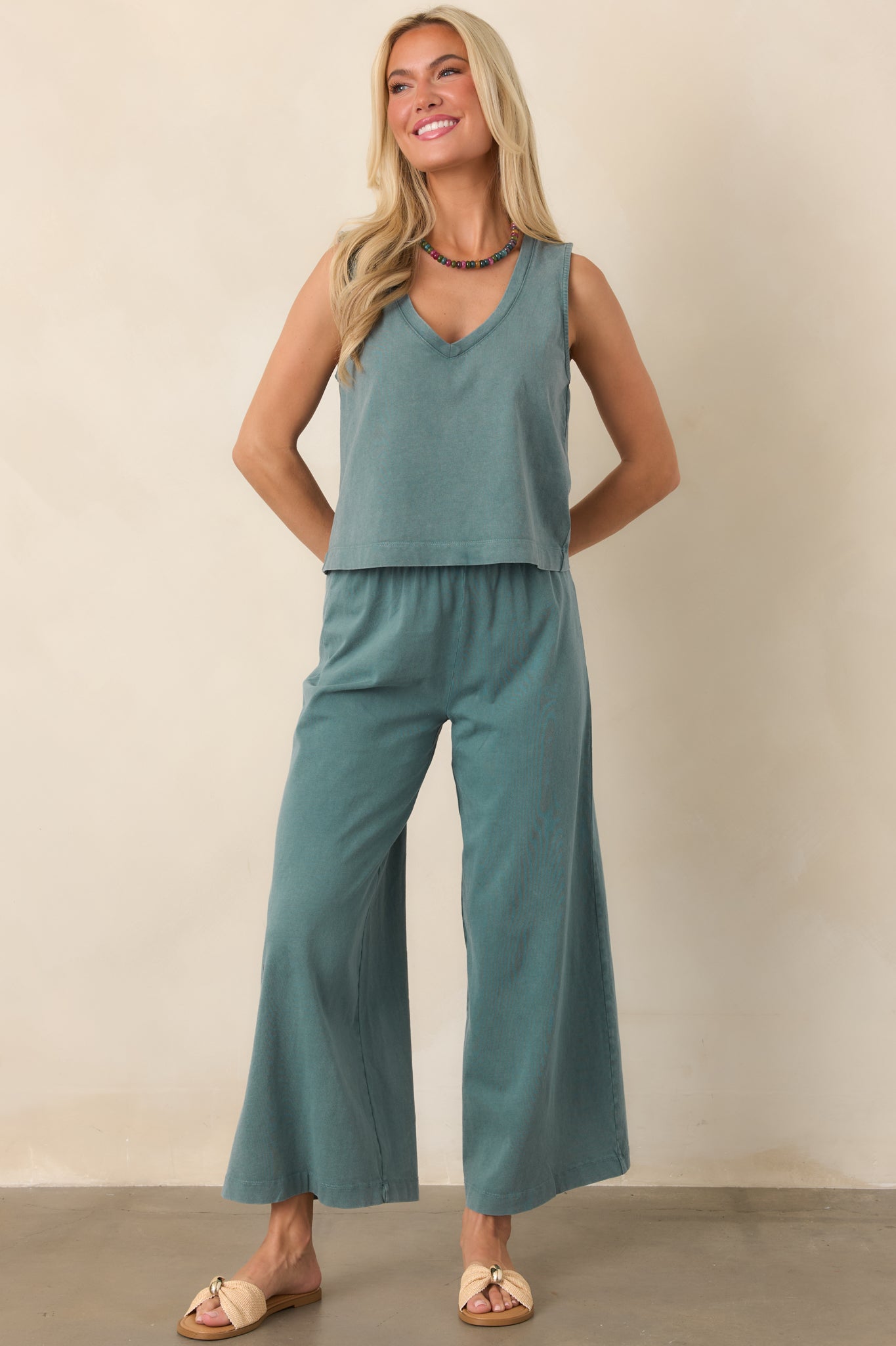 Soft Emerald Cove cotton pants with a comfortable elastic waist, functional side pockets, and an easy wide-leg silhouette ending at the ankles.