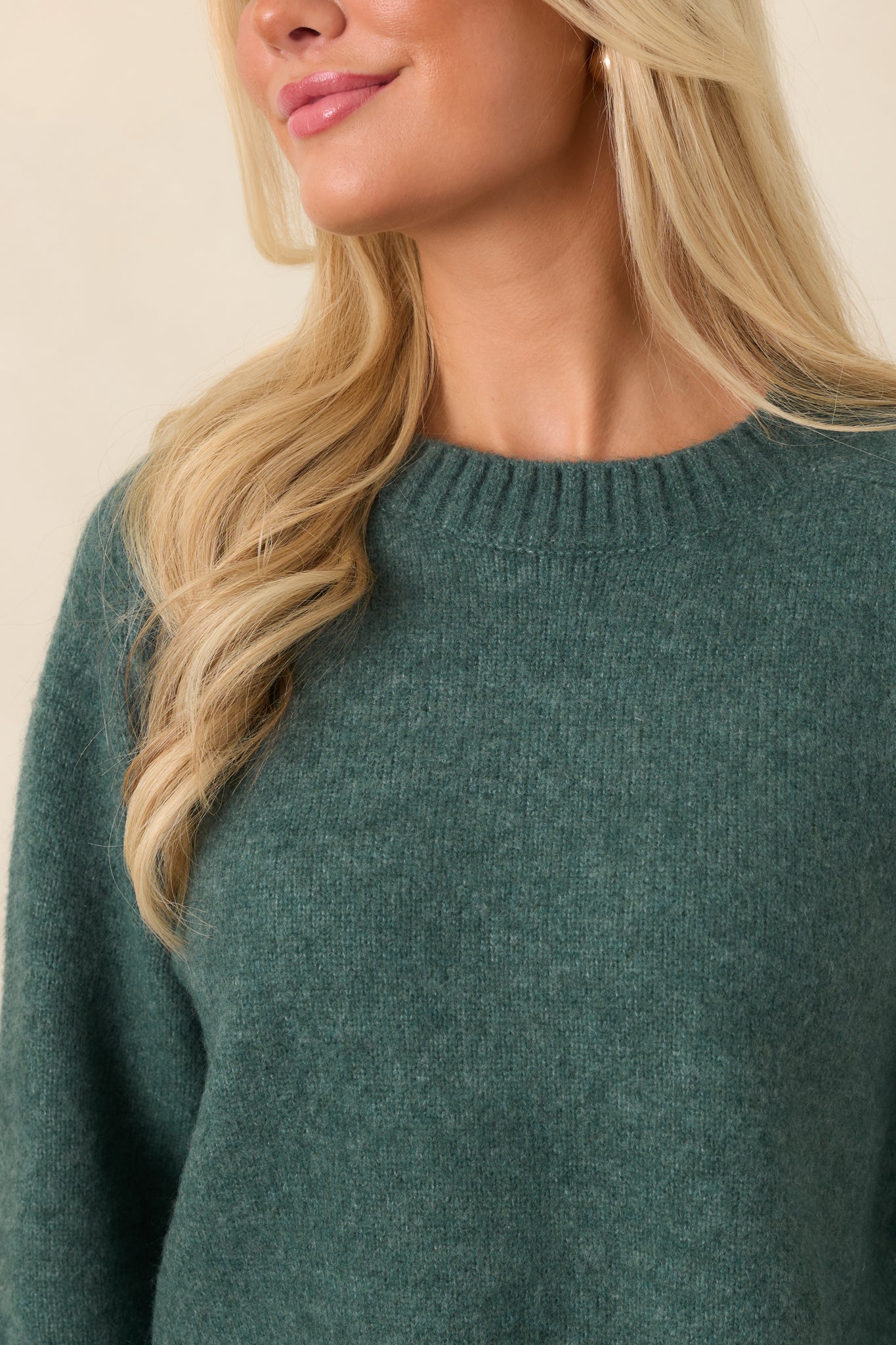 Close-up of the Emerald Cove green fuzzy knit texture with ribbed trim detailing along the neckline.