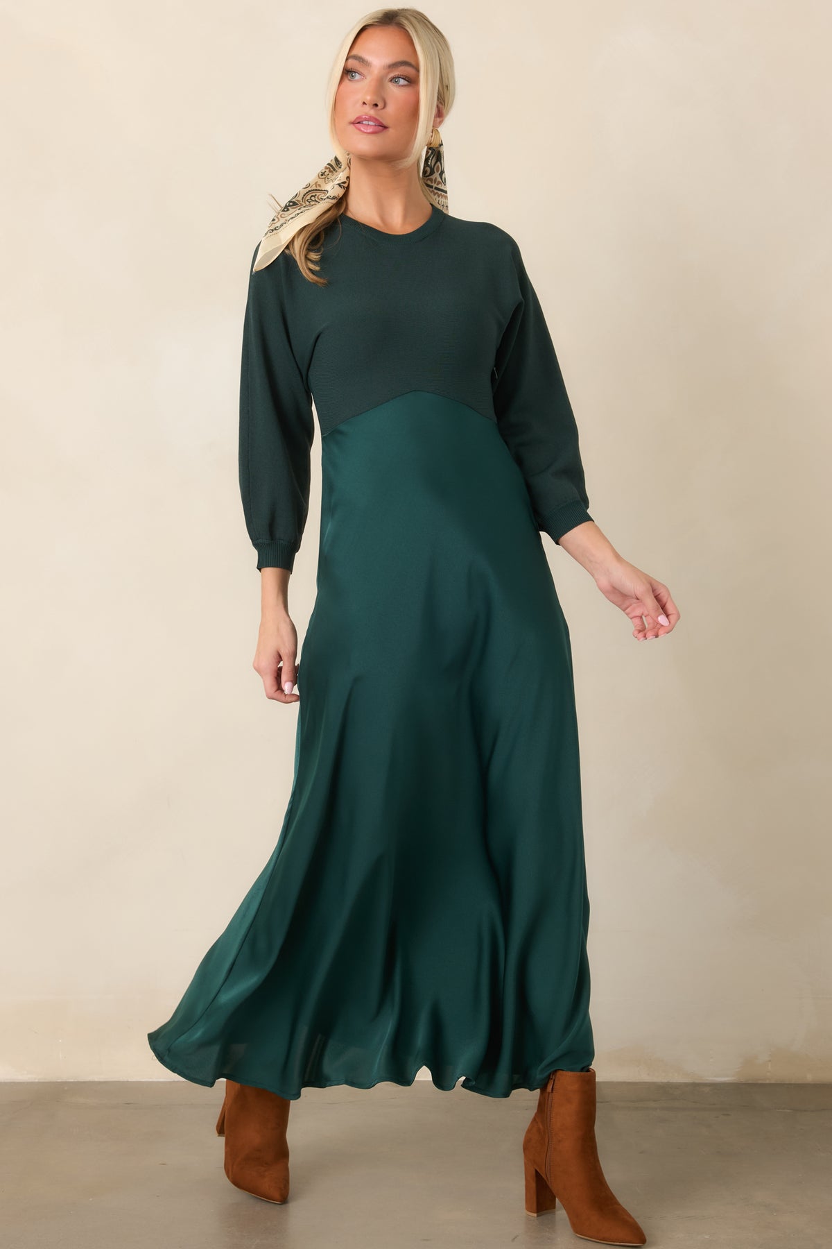 Sophisticated emerald midi dress with a fitted knit bodice and flowing satin skirt defined by a high waist.