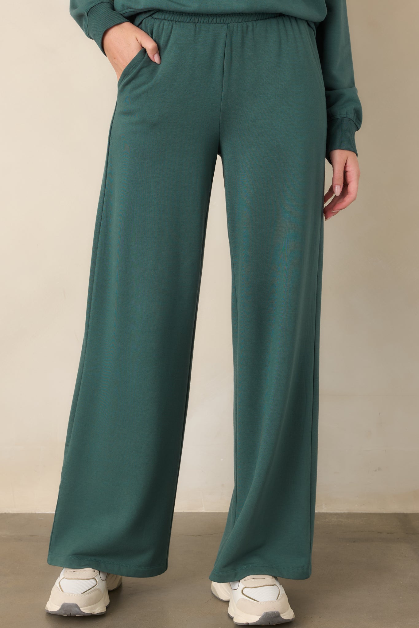 Emerald green modal-blend pants showcasing their relaxed fit and softly flowing wide-leg construction.