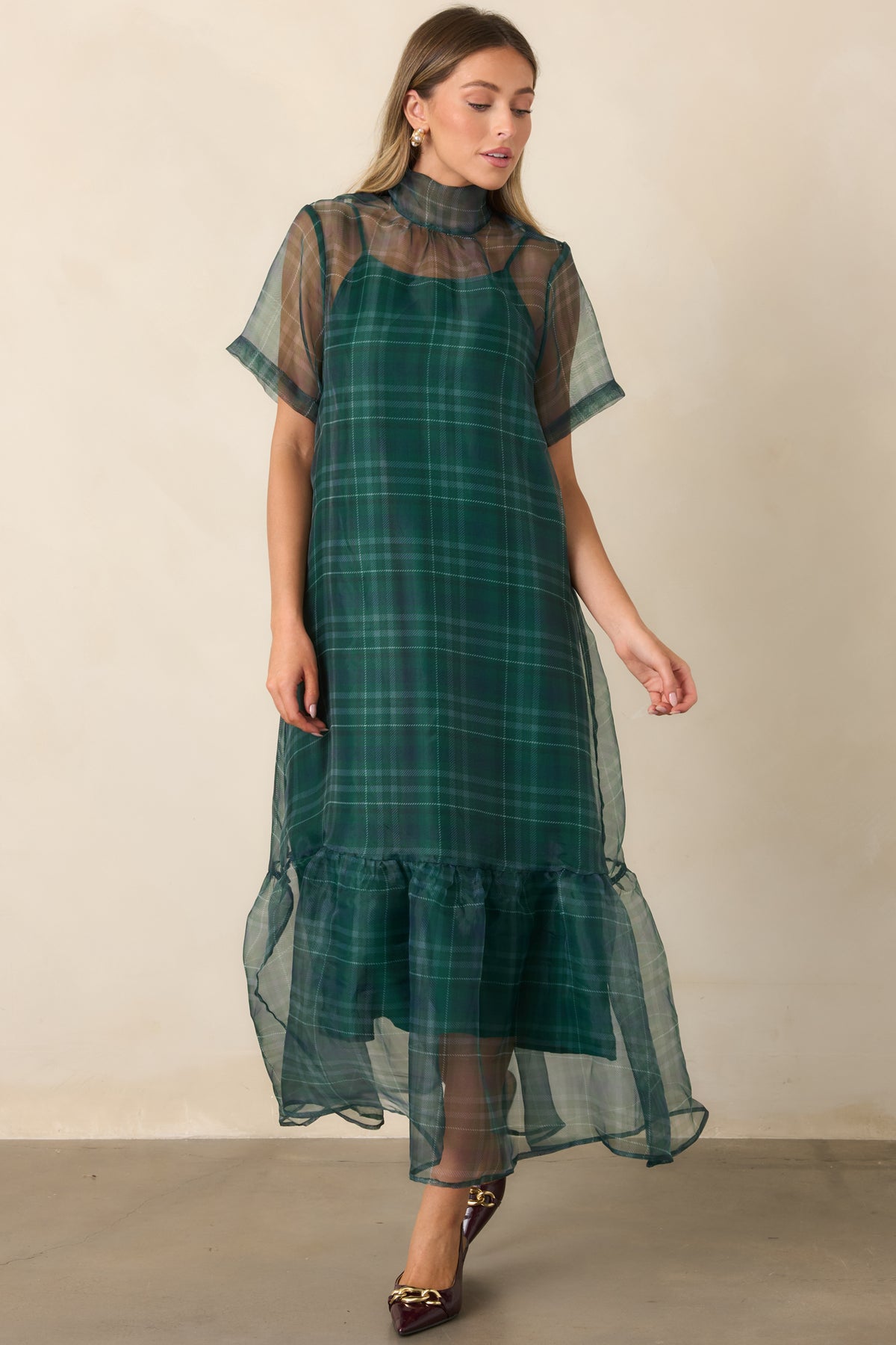 Rich green maxi dress combining a sheer plaid layer with a softly gathered lower flounce.