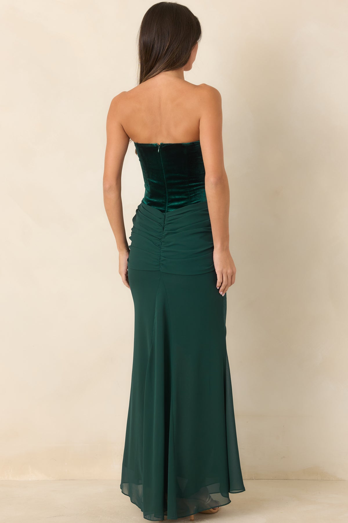 Rear of the emerald velvet maxi dress showing the back zipper and flowing chiffon skirt.