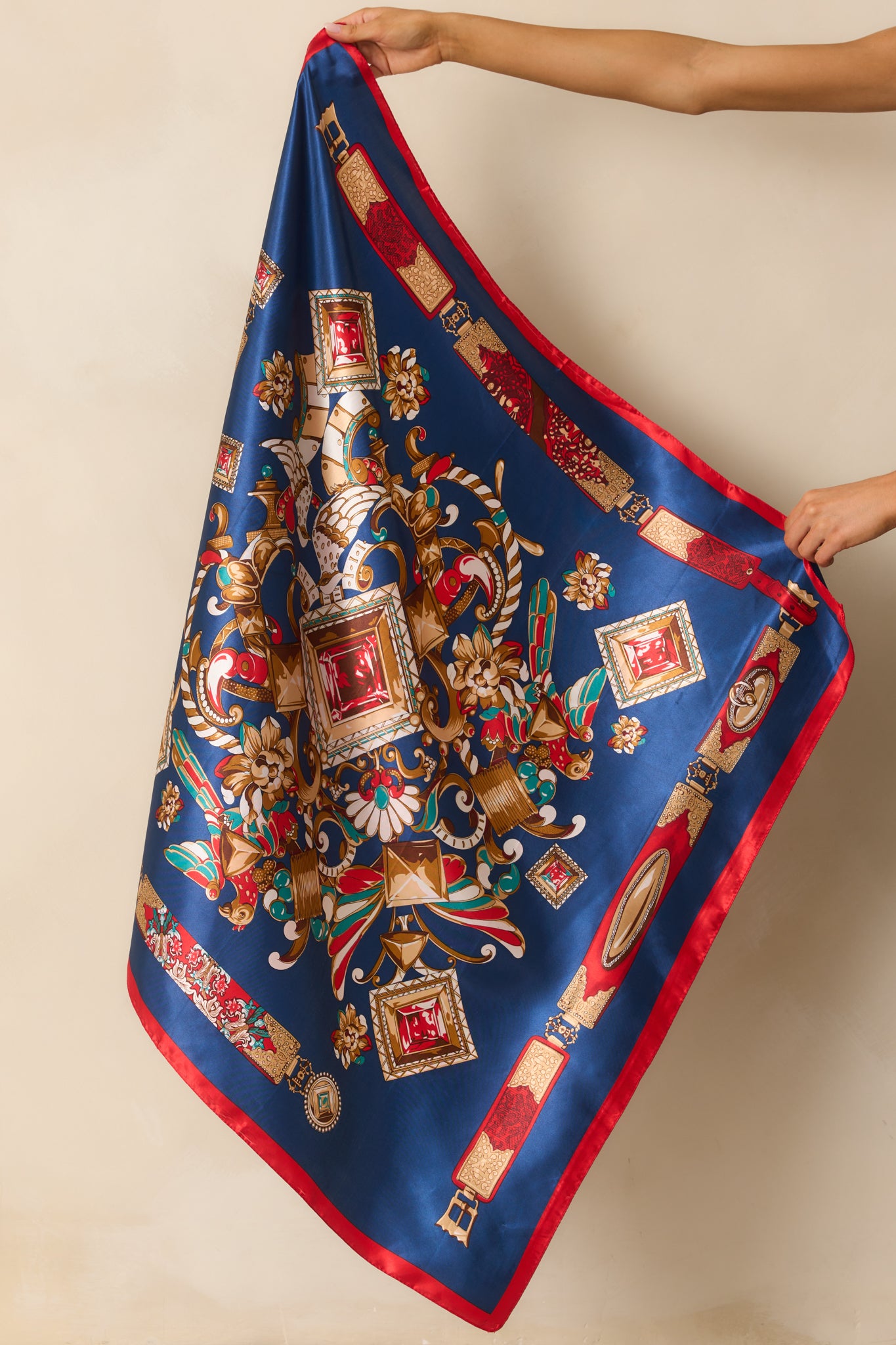 Entire scarf displayed with its soft satin sheen, emphasizing the vibrant mix of navy and multicolor geometric patterns.