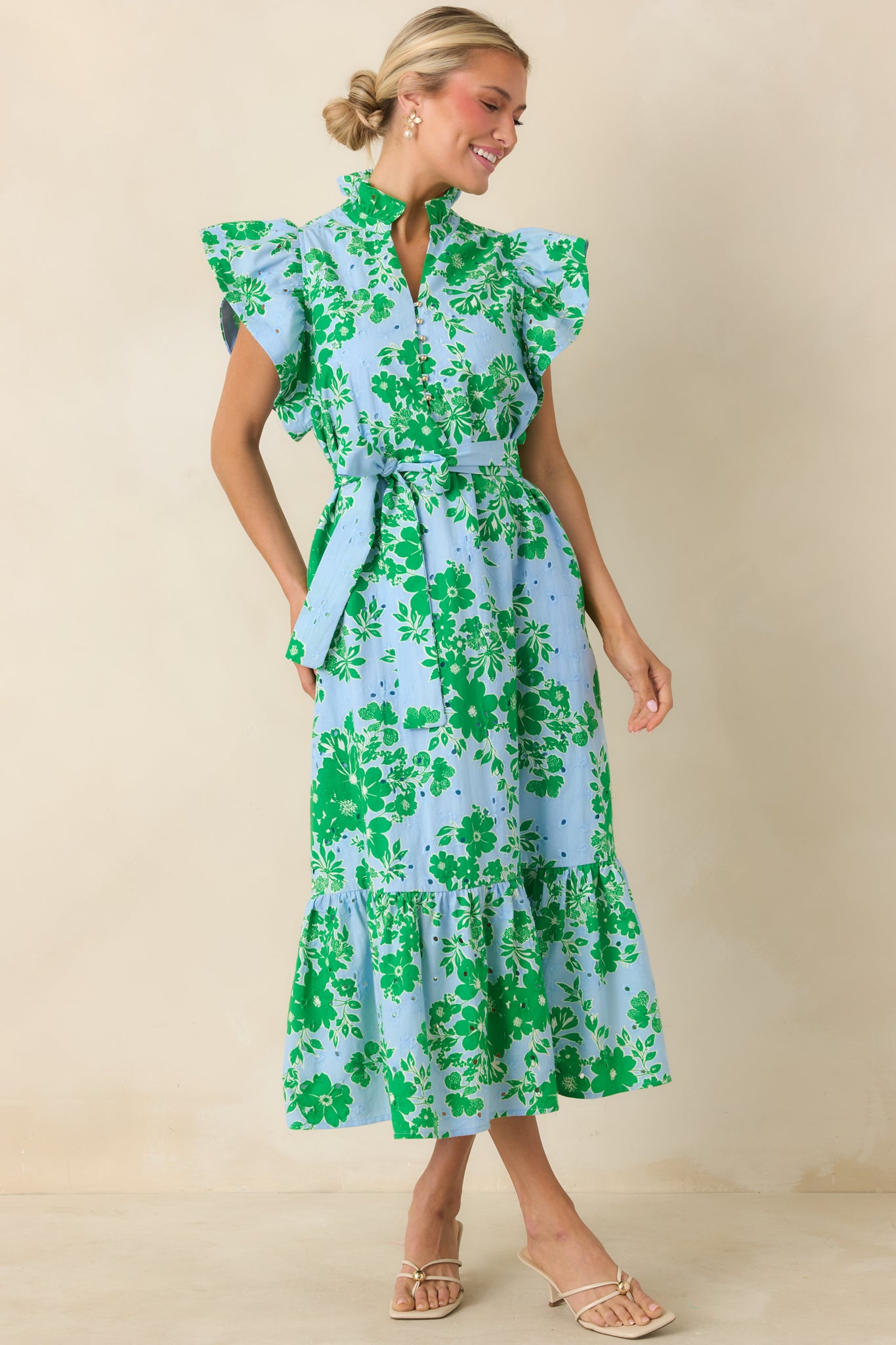 Eyelet embroidered midi dress with v-neck, flutter sleeves, and soft movement.