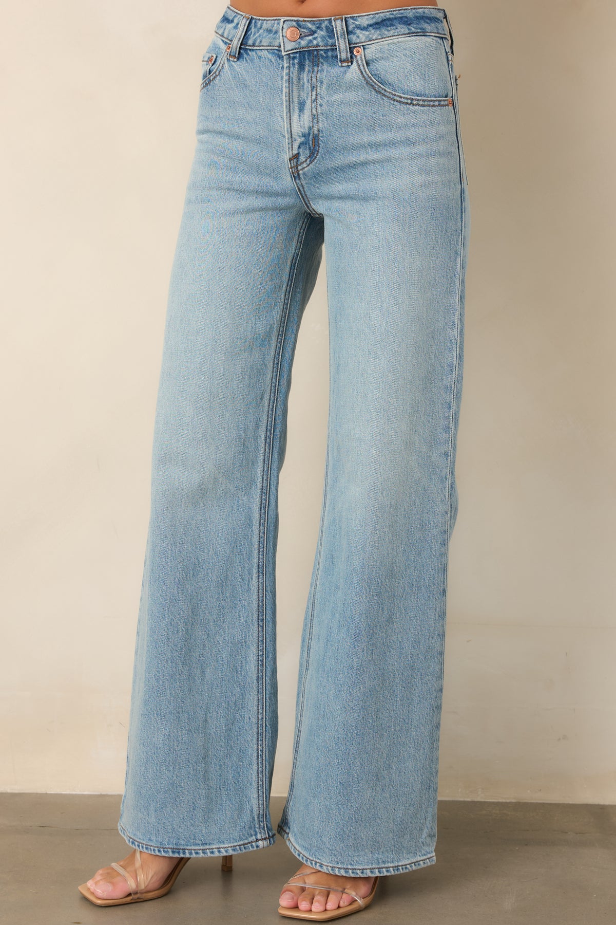 Faded cotton denim jeans featuring belt loops, a button closure, and subtle whiskering.
