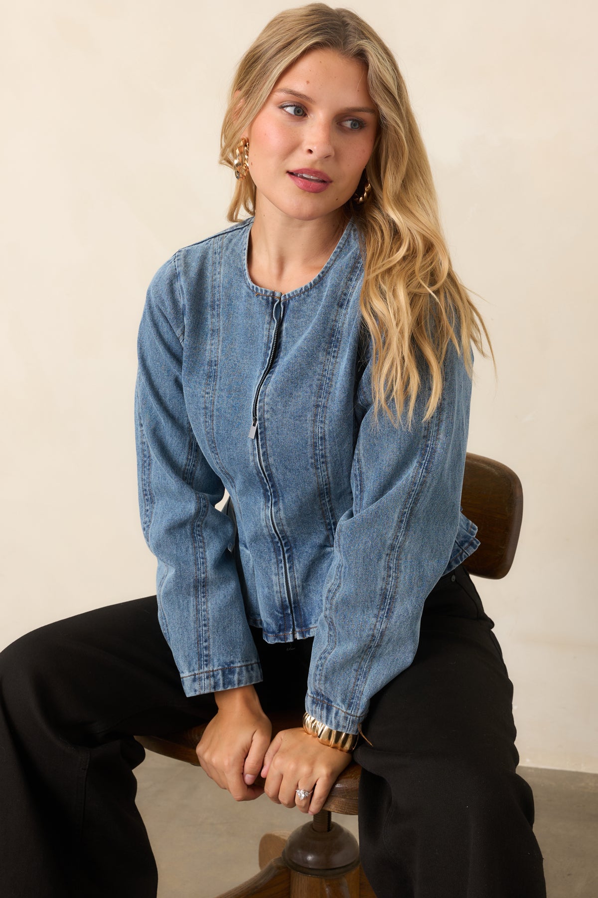 Faded cotton jacket highlighting the flared peplum hem and defined waist.