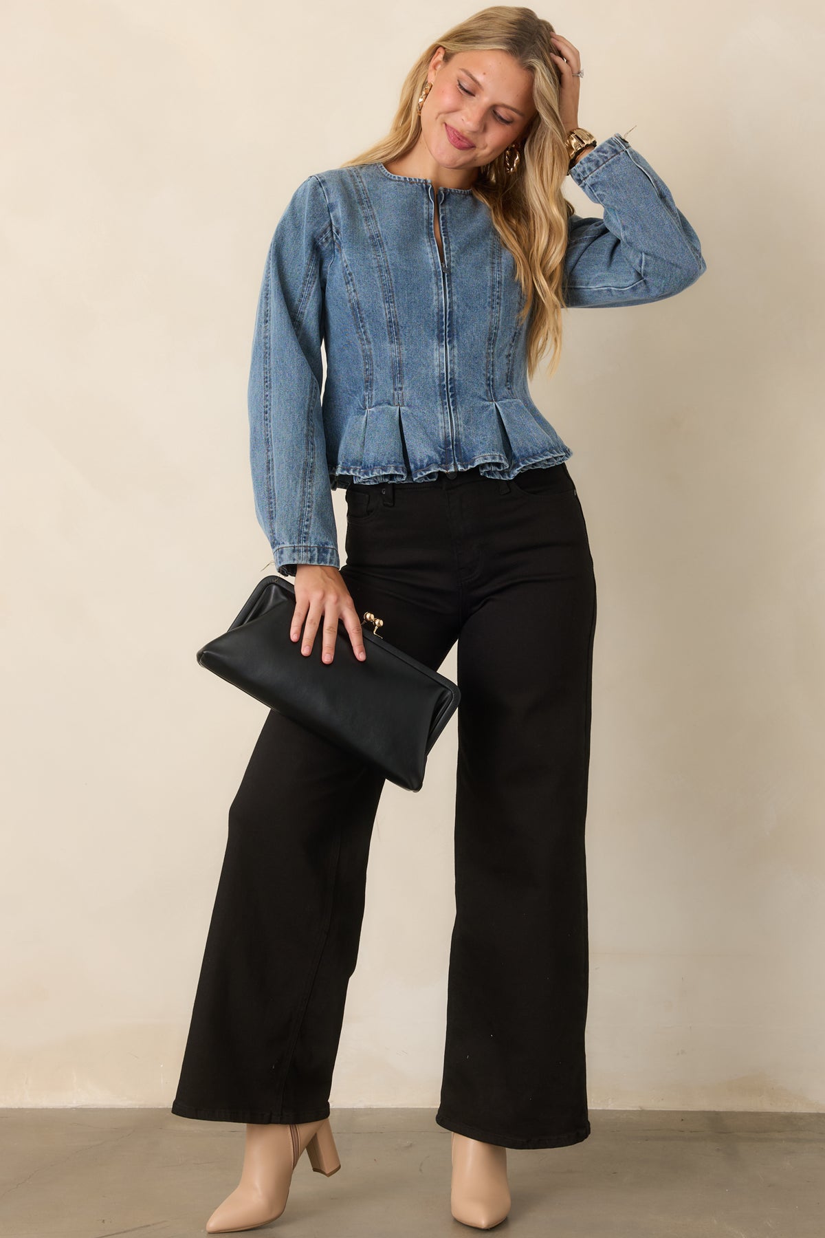 Faded medium wash jacket showcasing its fitted, sculpted silhouette.
