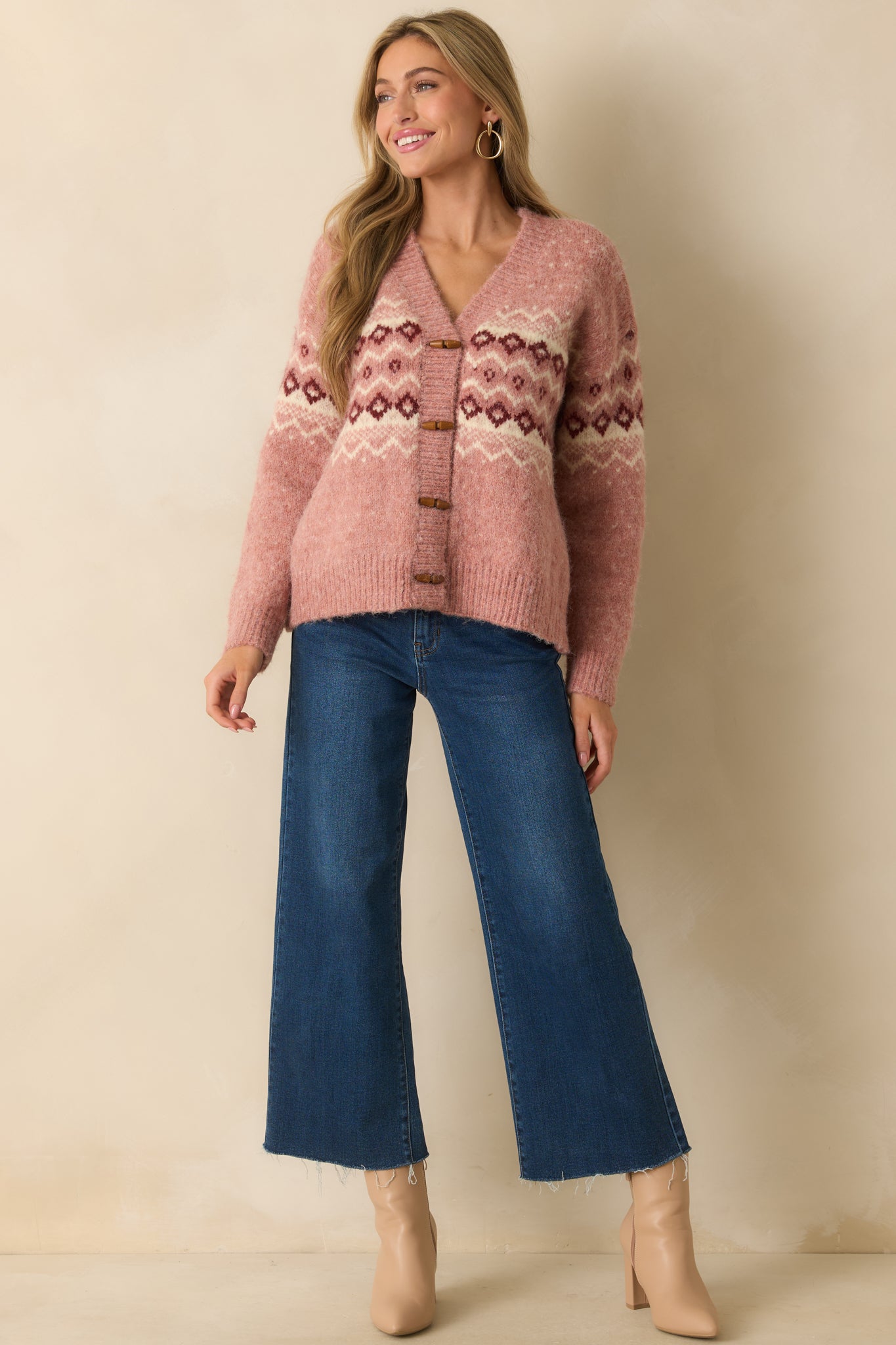 Front-facing cardigan with a classic v-neck and decorative Fair Isle design.