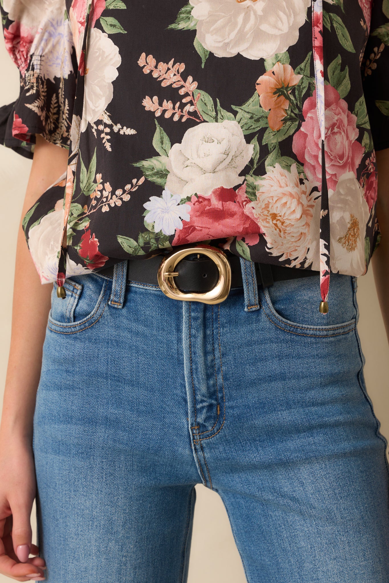 A cropped front view showing the adjustable pin closure and smooth faux leather strap.