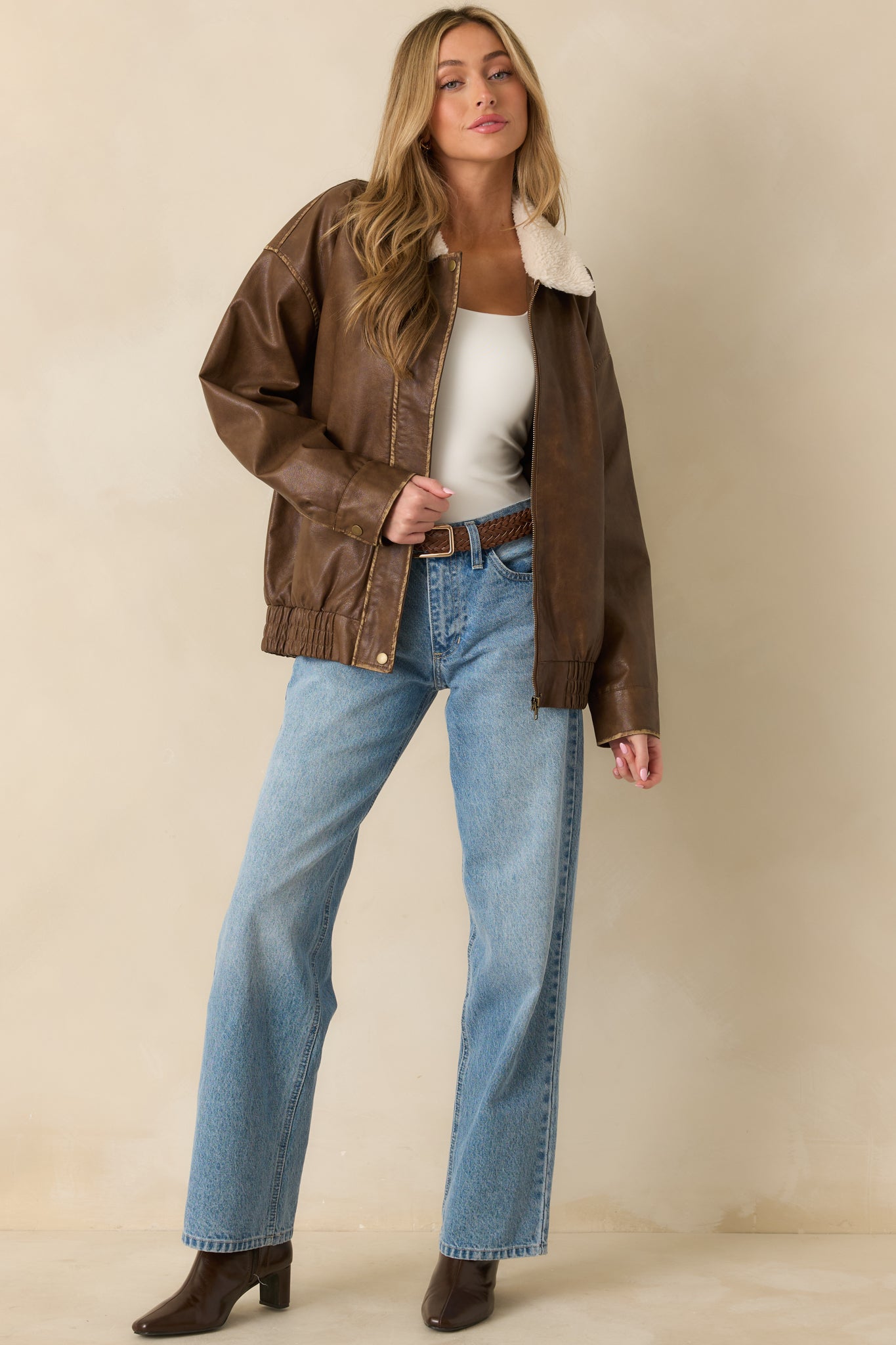Faux leather bomber jacket with its elasticized hem creating a secure, easy-layering fit.