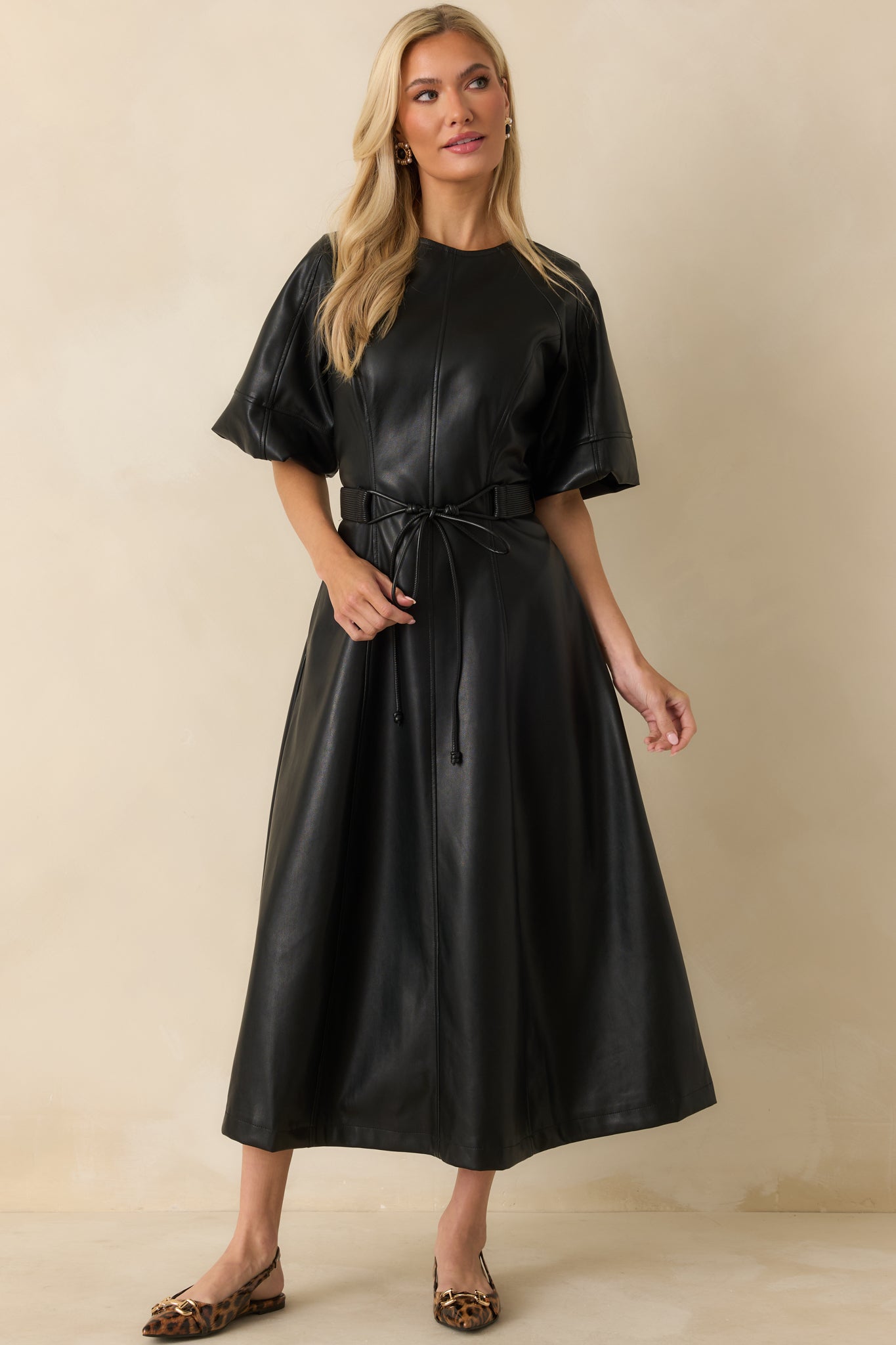 Faux leather midi dress featuring a classic crew neckline and short raglan sleeves.