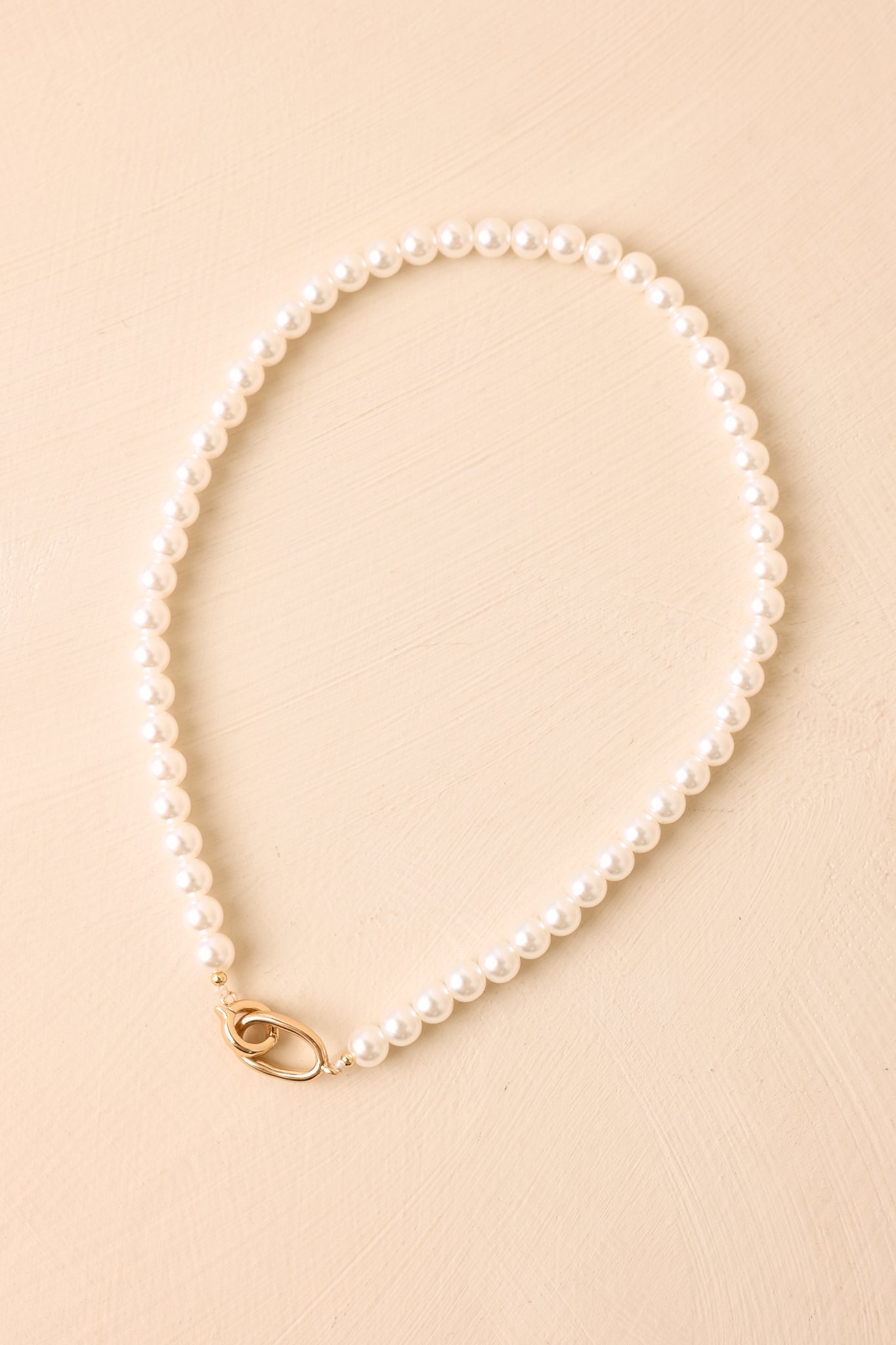 Polished to Perfection faux pearl necklace featuring a strand of lustrous faux pearls accented by a polished gold-tone hinged clasp.