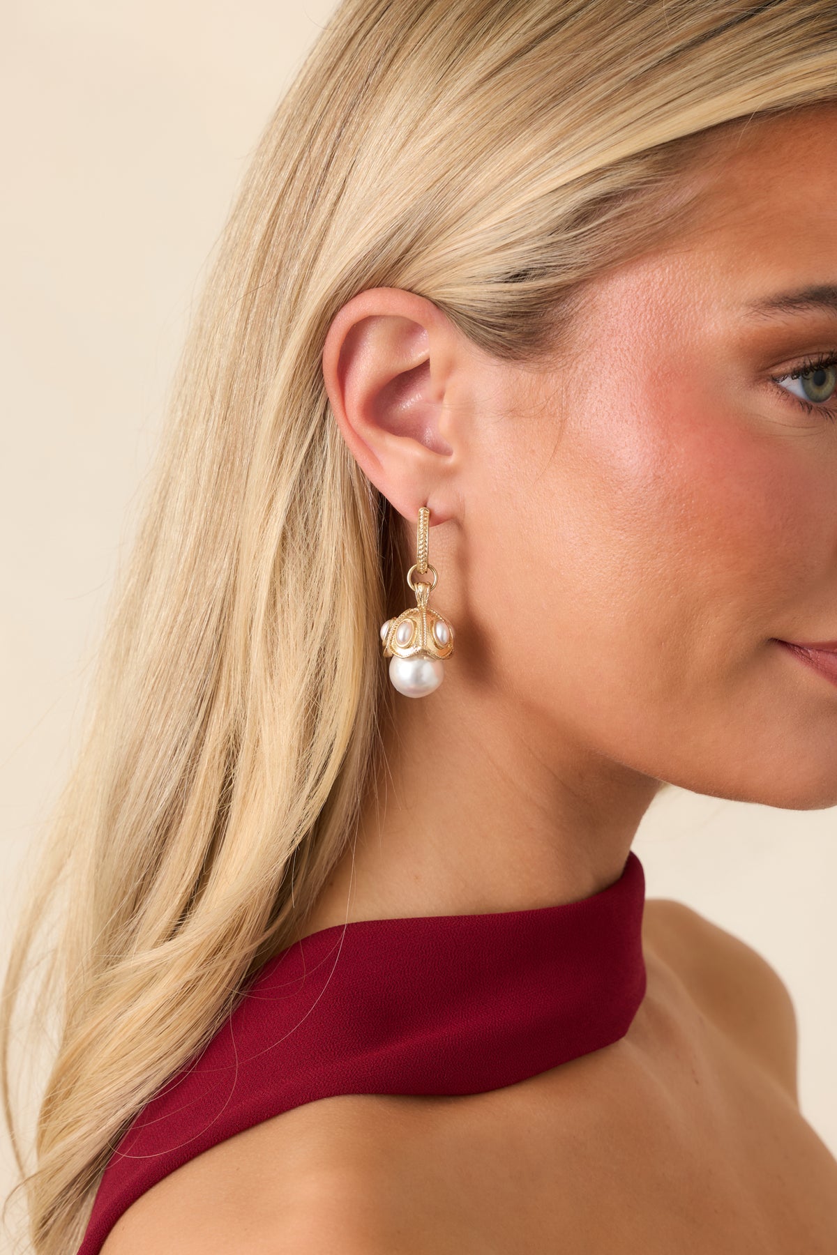Statement faux pearl earrings featuring textured gold hardware and smaller pearl embellishments.