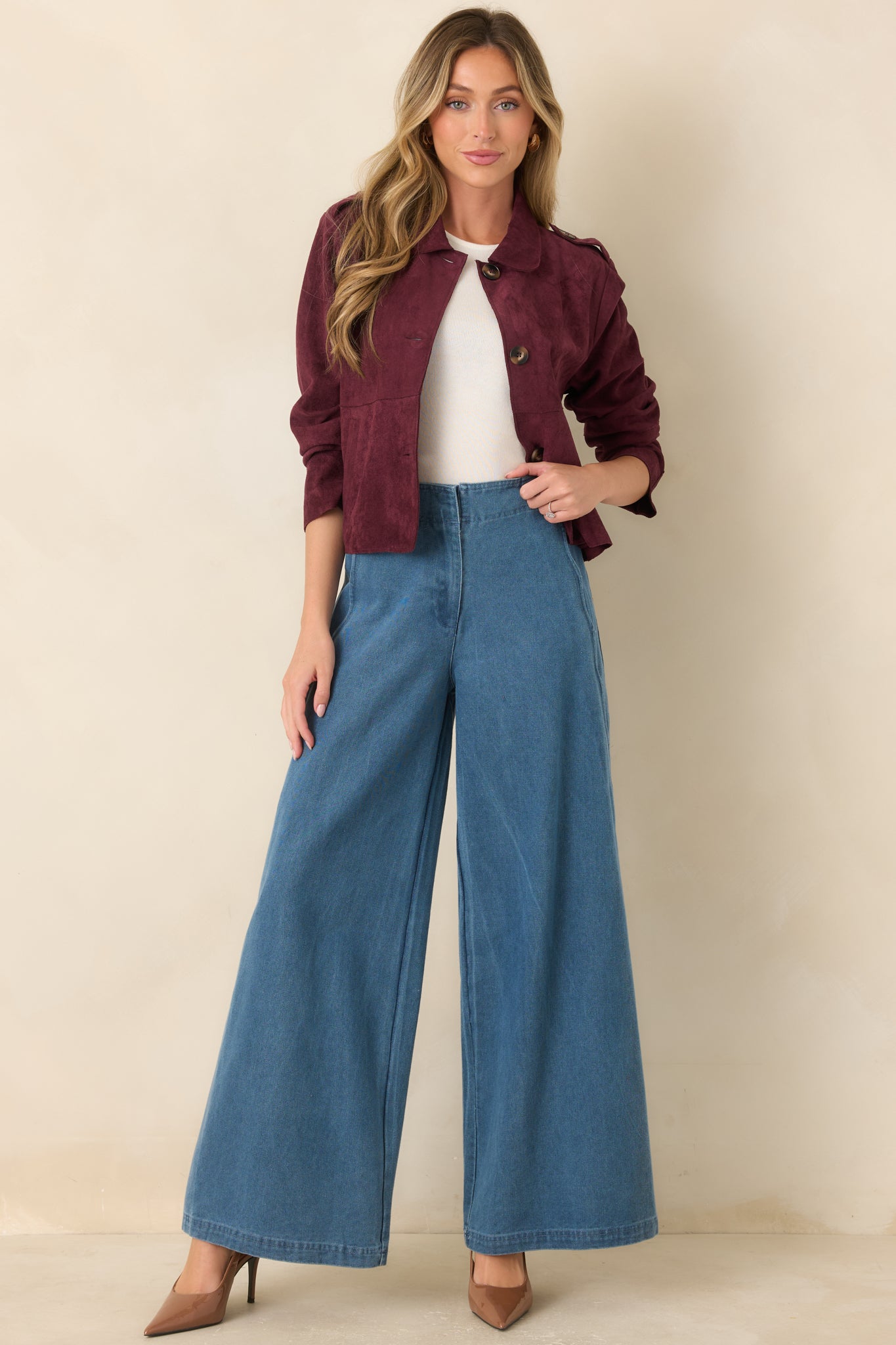 Soft faux suede cropped jacket featuring a rounded collar, functional button-front closure, shoulder tabs, and oversized front patch pockets for a polished, tailored look.