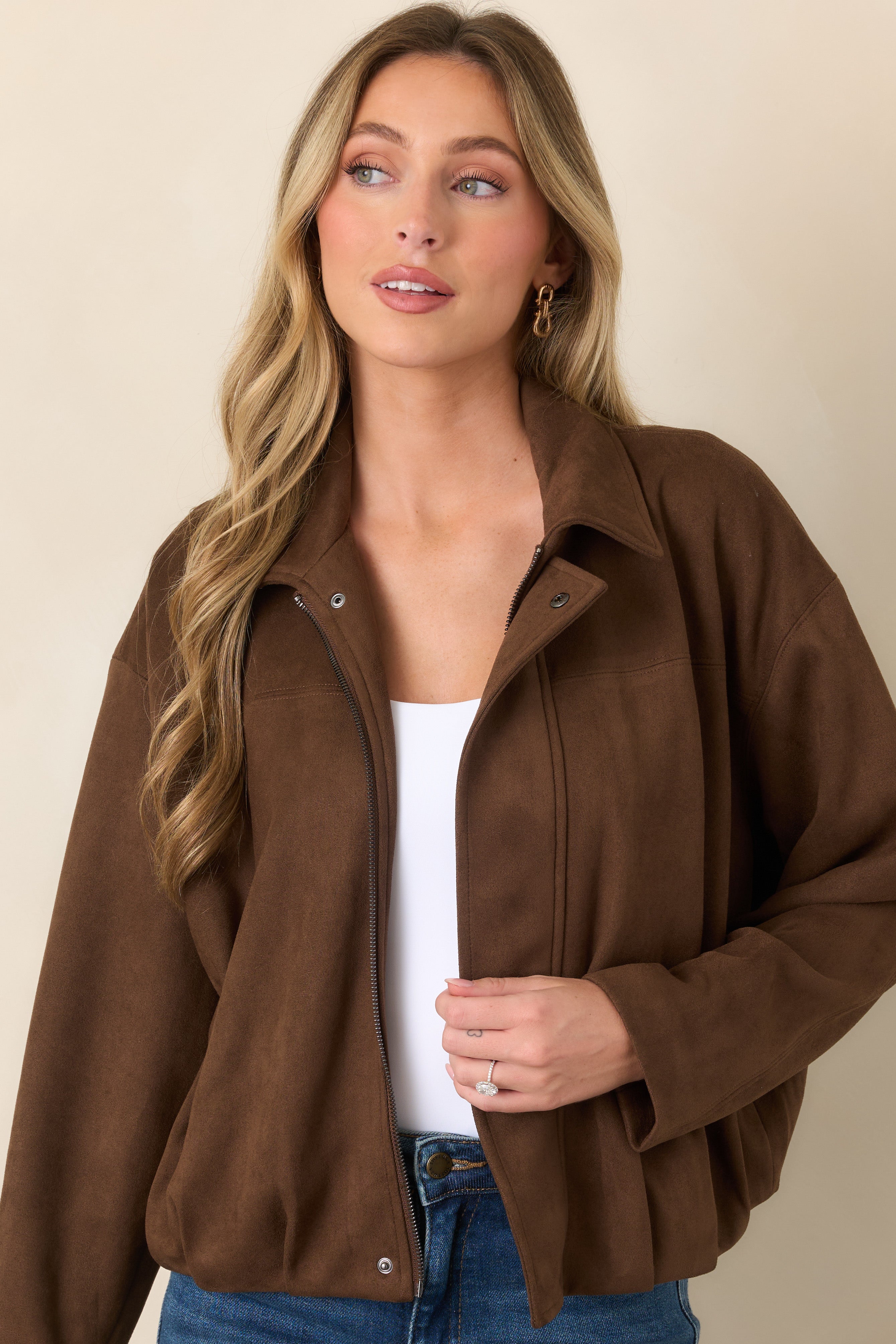 Detailed view of the jacket's dropped shoulder construction, smooth faux suede texture, and subtle seam detailing.