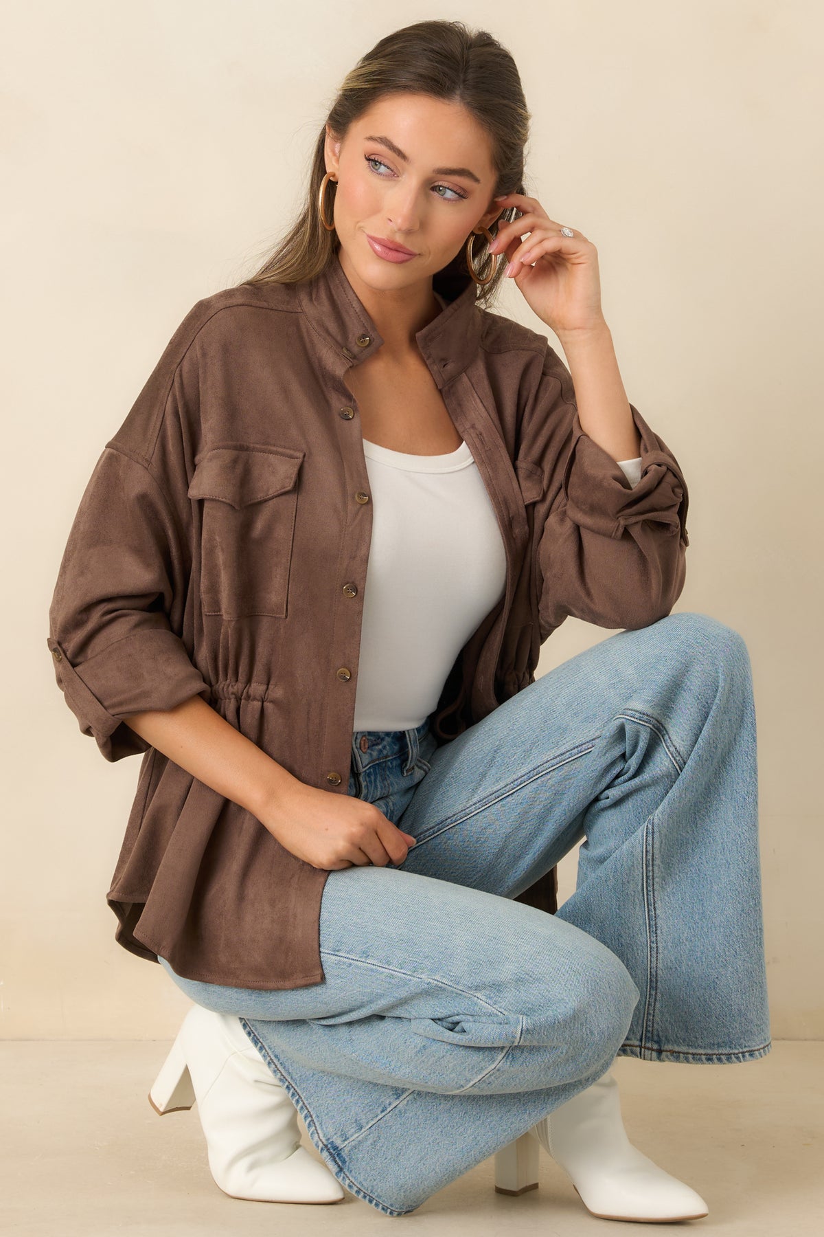 Stand collar and button-front closure on the soft faux suede jacket.