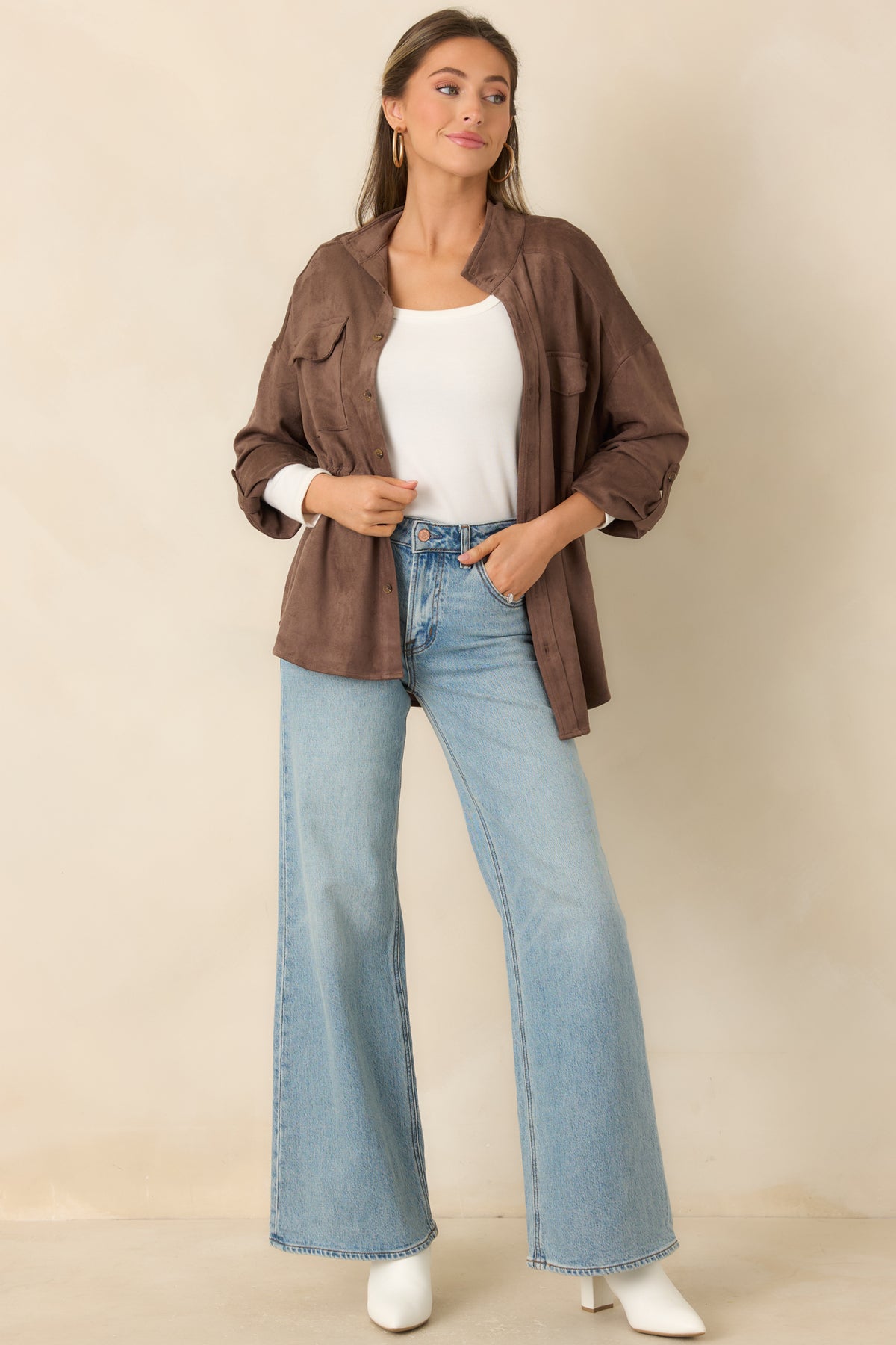 Faux suede jacket with a stand collar, button front, flap chest pockets, and a relaxed fit.