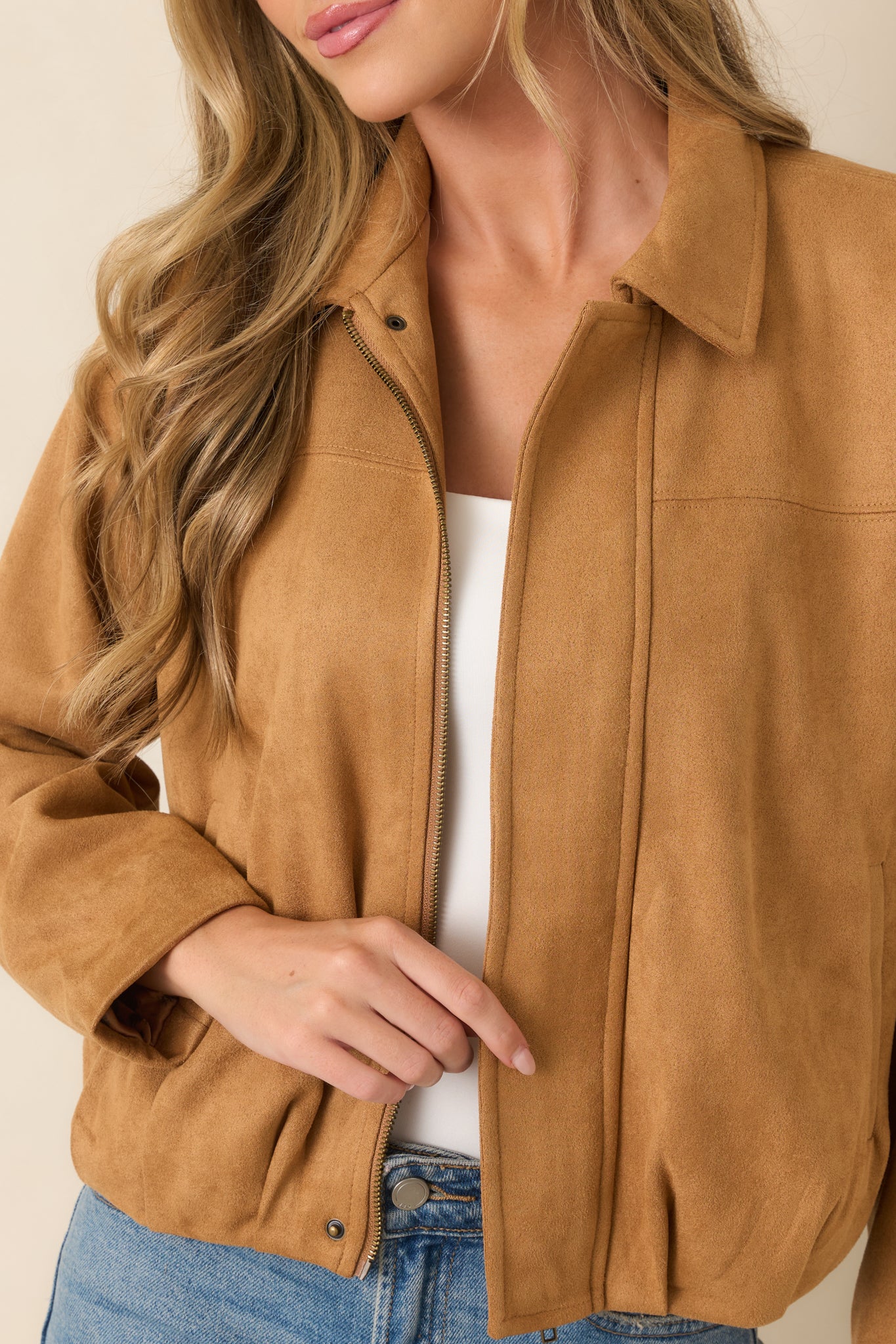 Close-up of the faux suede jacket highlighting the soft stretch texture, concealed zipper placket, and precise seam detailing.
