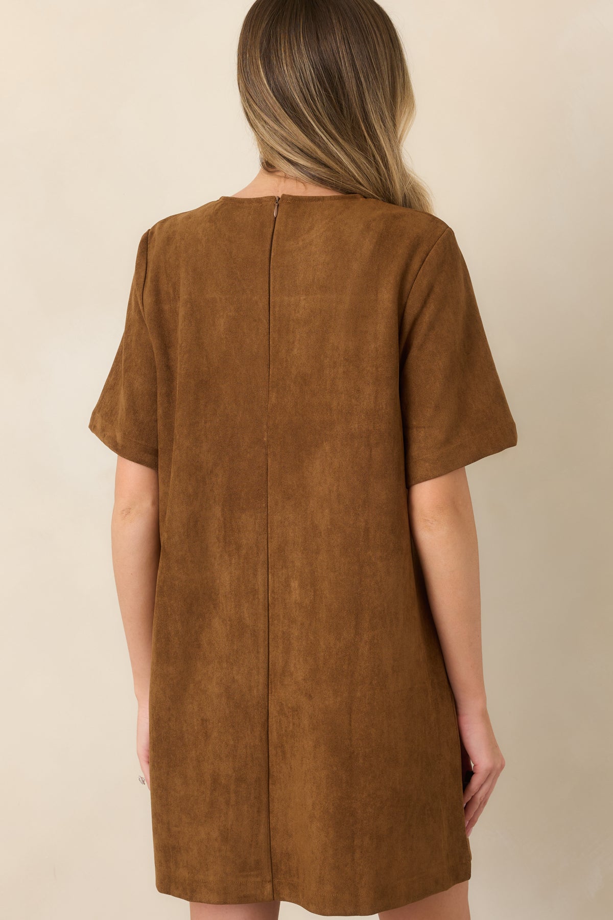 Rear of the soft stretch faux suede mini dress showing the smooth finish and concealed back zipper closure.