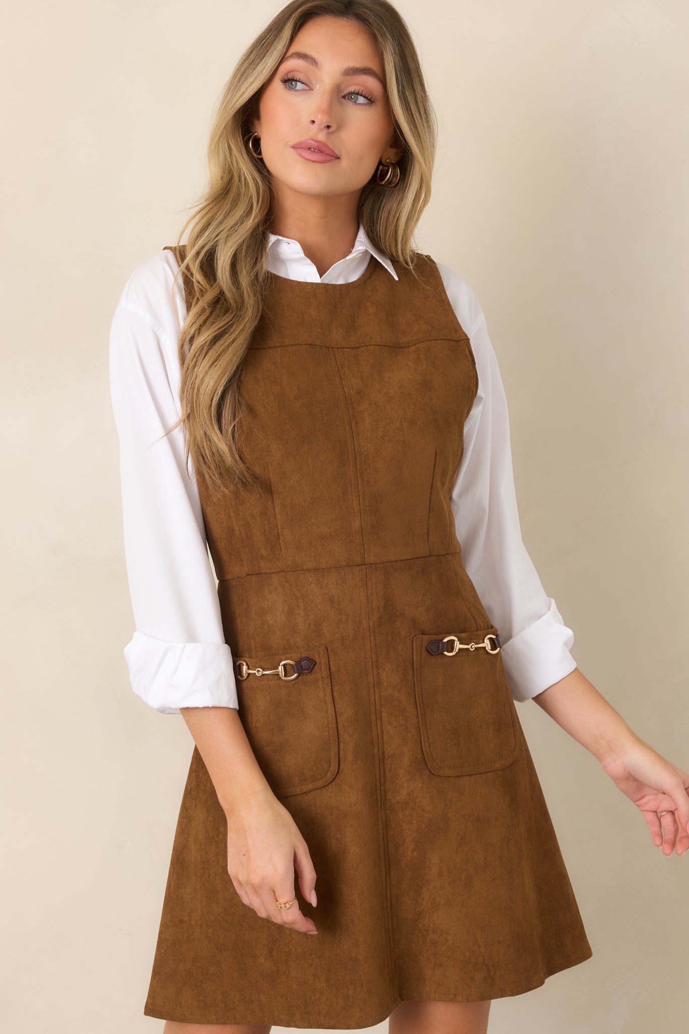 Soft suede-textured mini dress featuring tailored seams, a sculpted waist, and a gently flared skirt with clean construction.