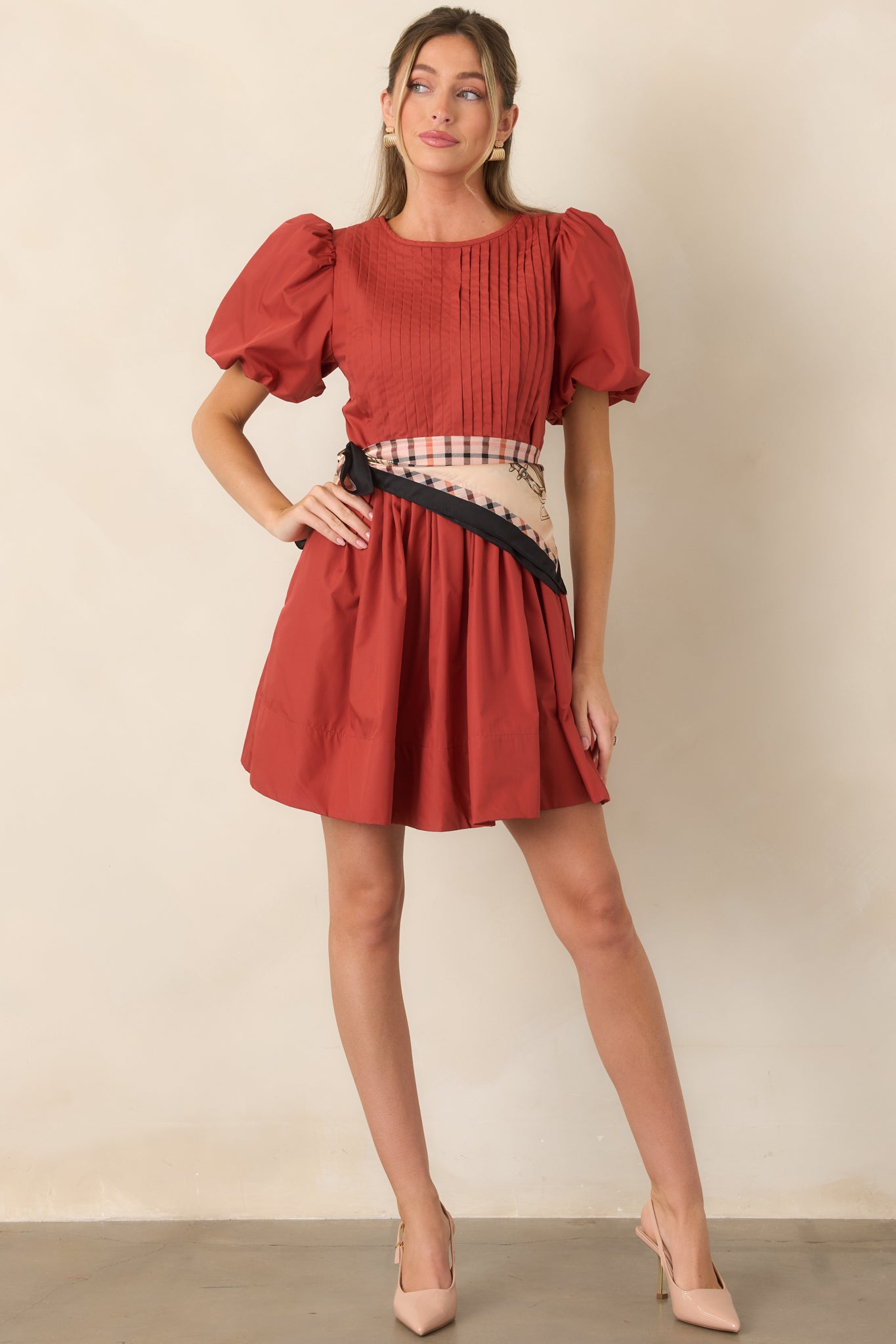 Feminine mini dress with pintucked front and back bodice, statement puff sleeves, and an airy full skirt.