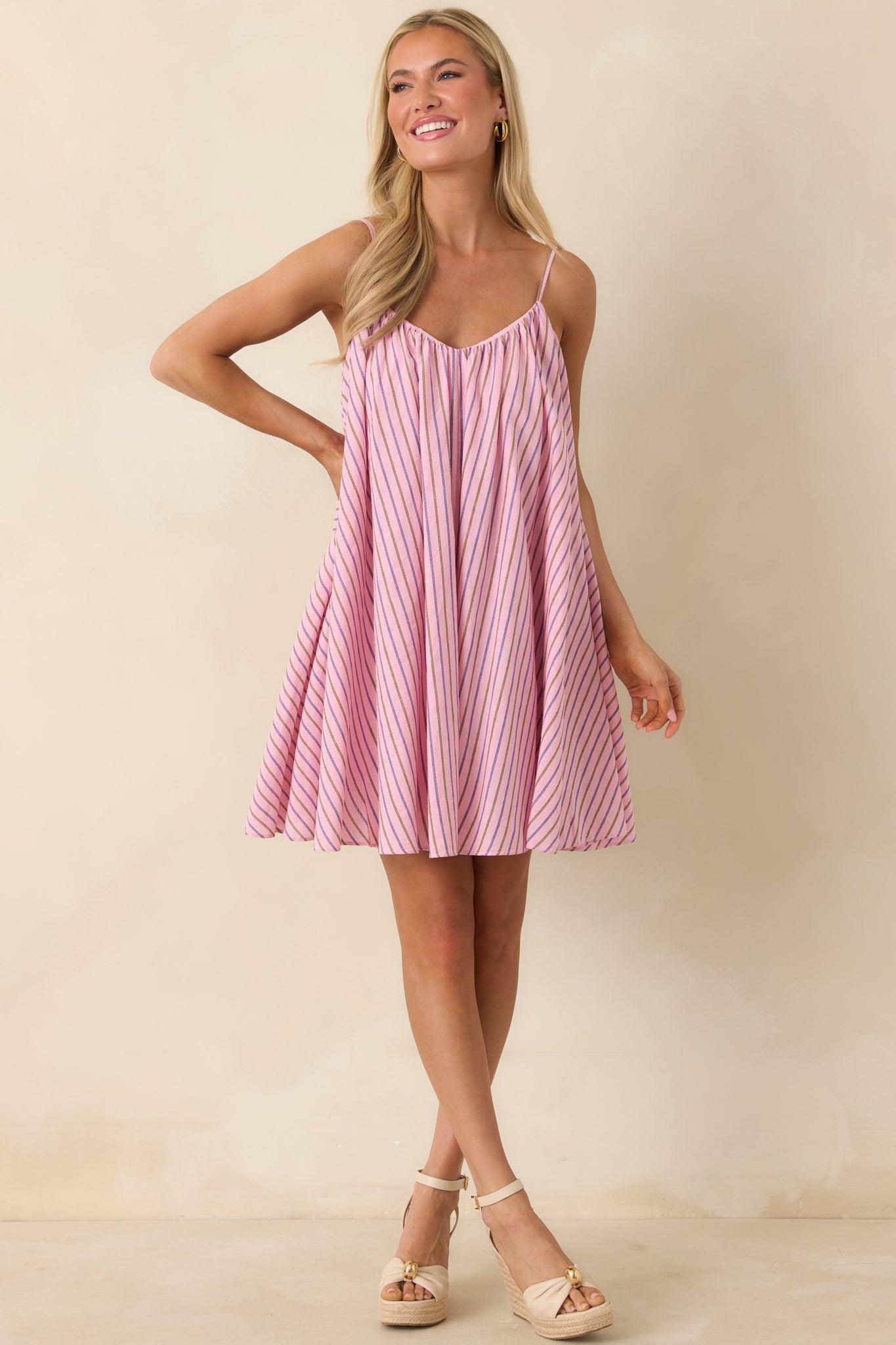 Feminine striped mini dress with flowy shape and lightweight feel.