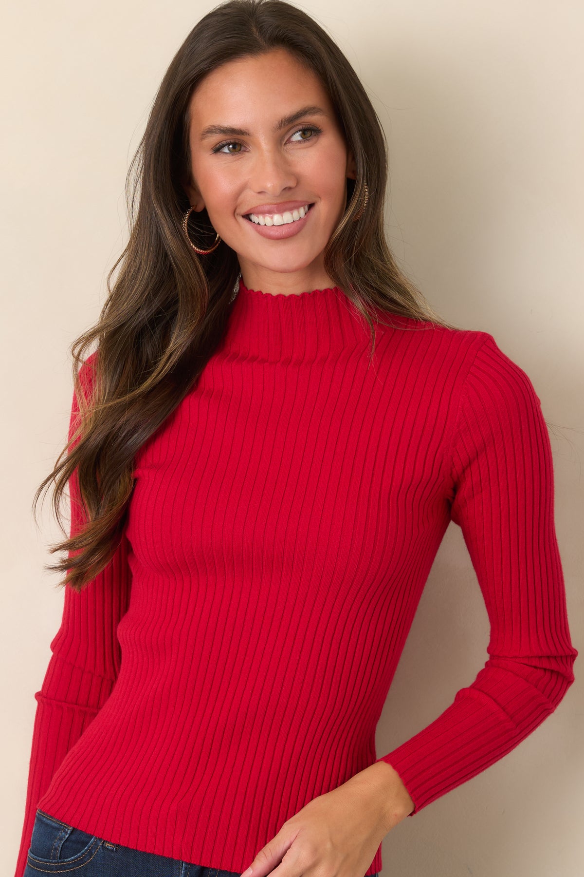Finely ribbed top showcasing the sleek shape and softly detailed mock neckline.