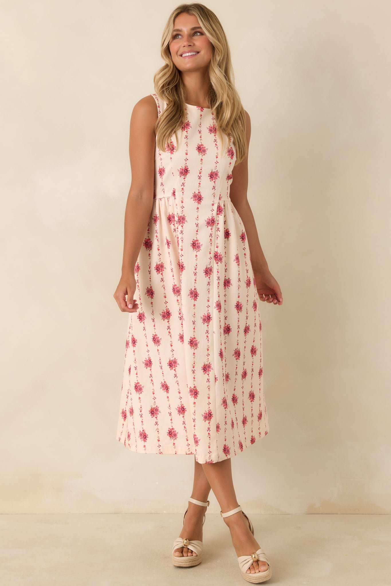 Fit-and-flare midi dress showcasing a sleeveless design, princess seams, delicate floral stripes, and a polished tailored shape.