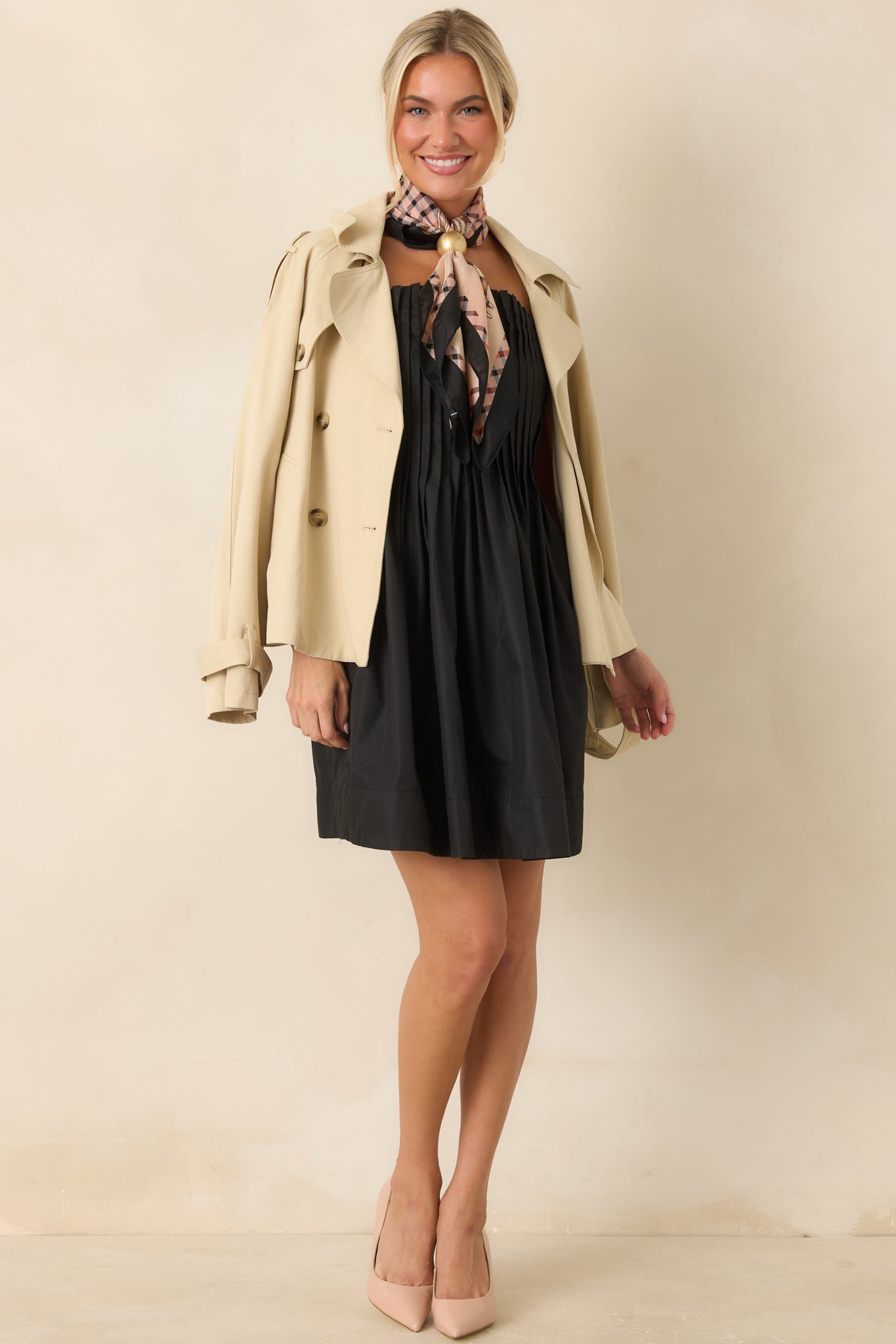 Fit-and-flare mini dress featuring soft gathers, adjustable shoulder straps, and timeless black styling.
