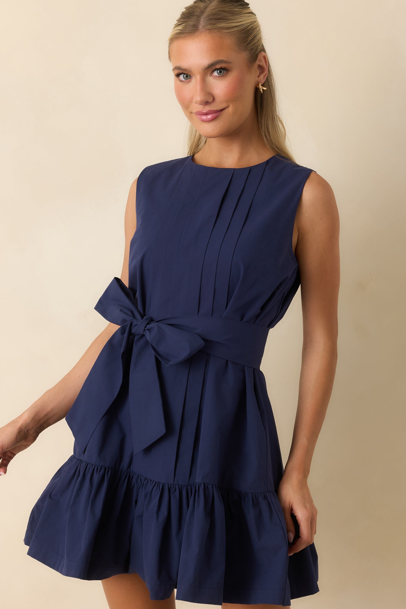 Close-up of the fit-and-flare silhouette highlighting the gathered waist and playful ruffled hemline.