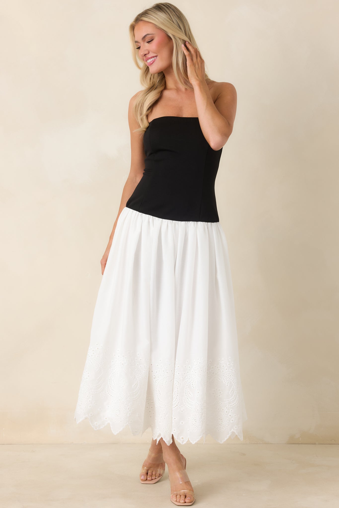 Fitted bodice midi dress with cotton eyelet skirt and functional side pockets.