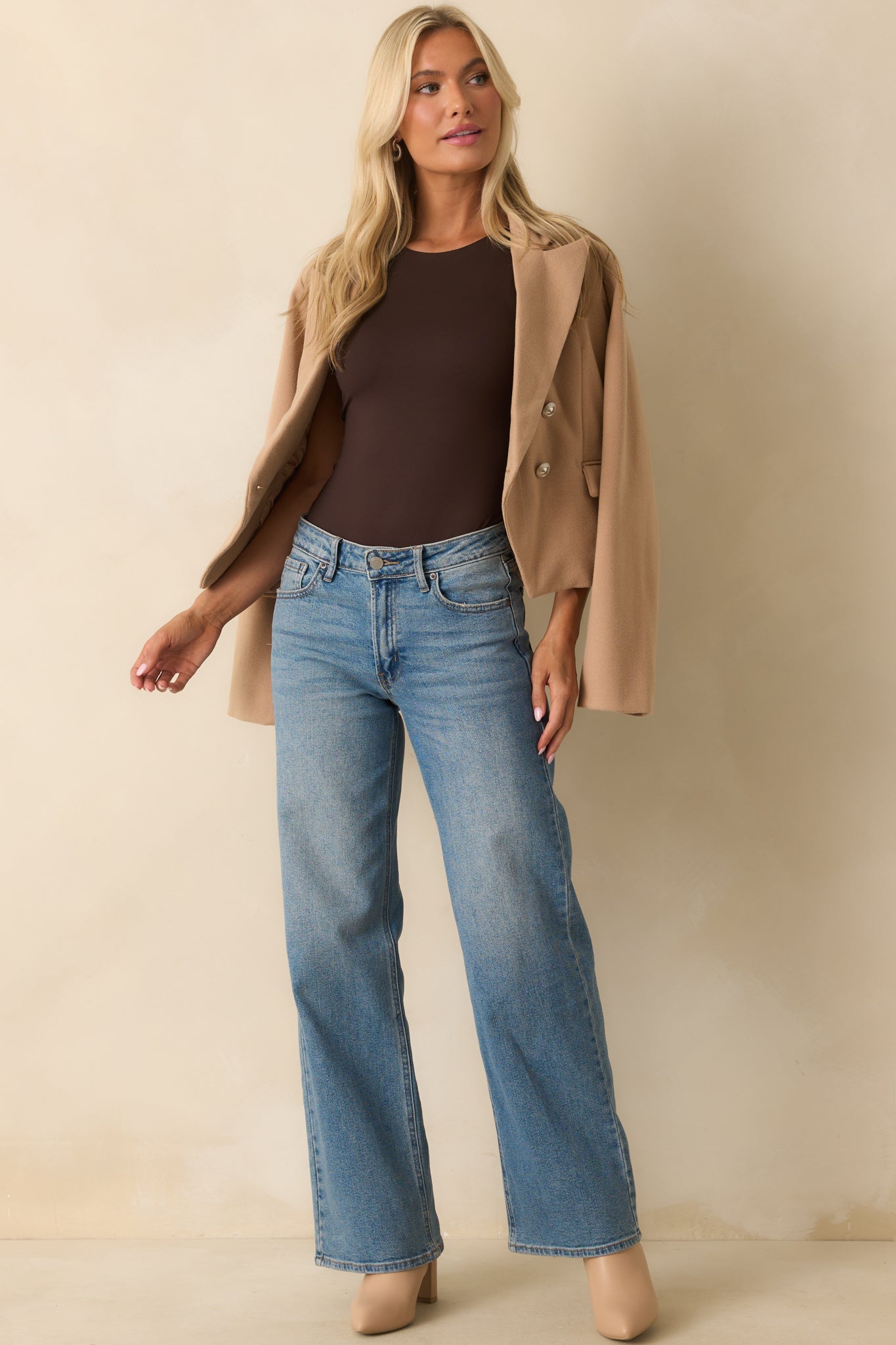 Fitted bodysuit in dark brown featuring a smooth stretch-knit fabric and high neckline.