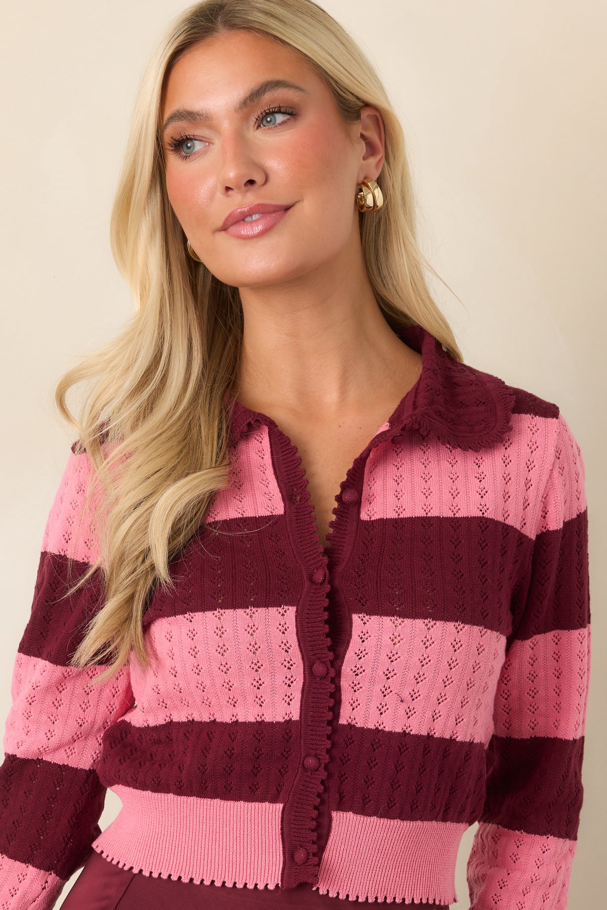 Fitted knit cardigan with long sleeves and a shorter hem finished with feminine scalloped edging.