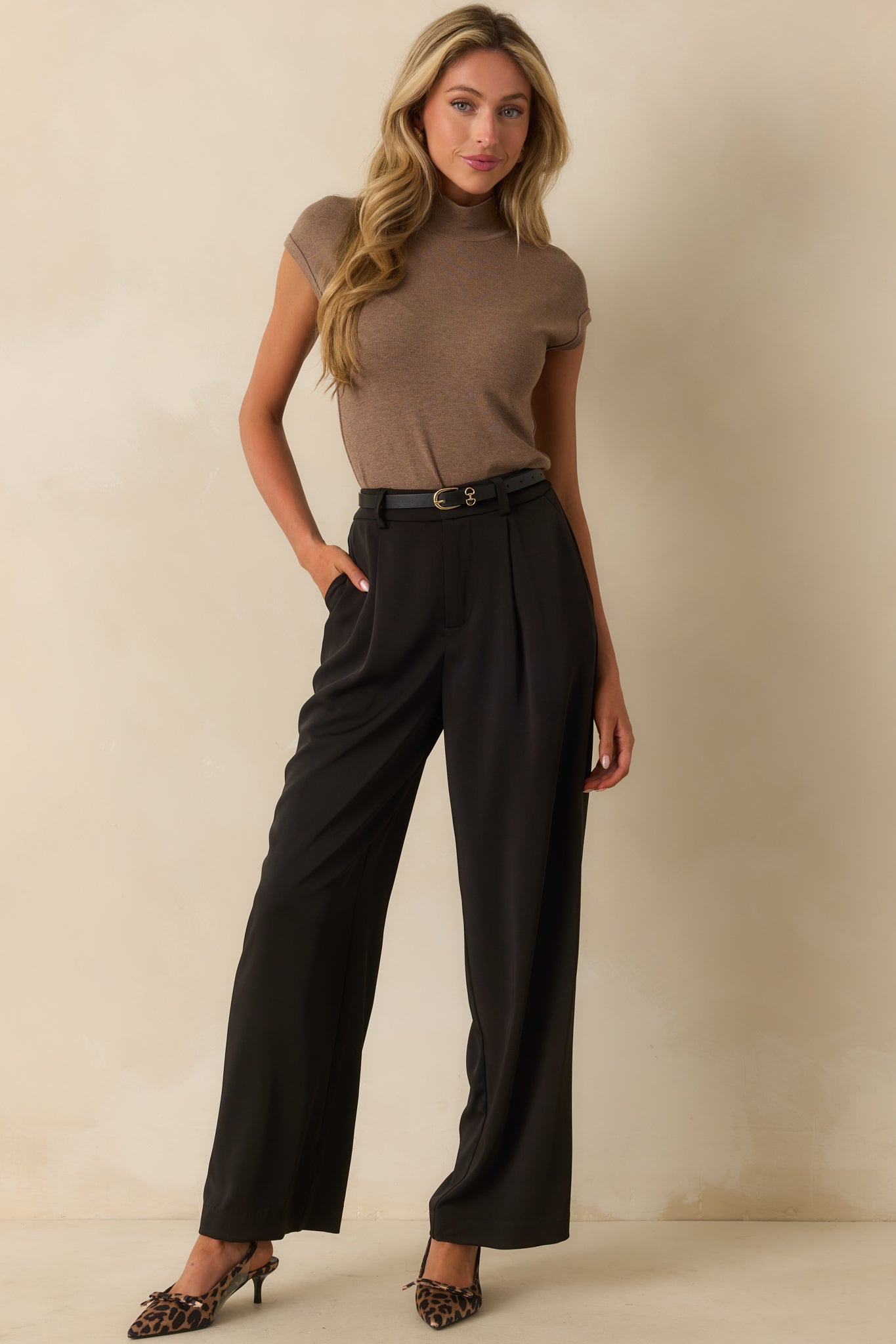 Fitted mocha top featuring rolled cuffs and a structured mock neckline.