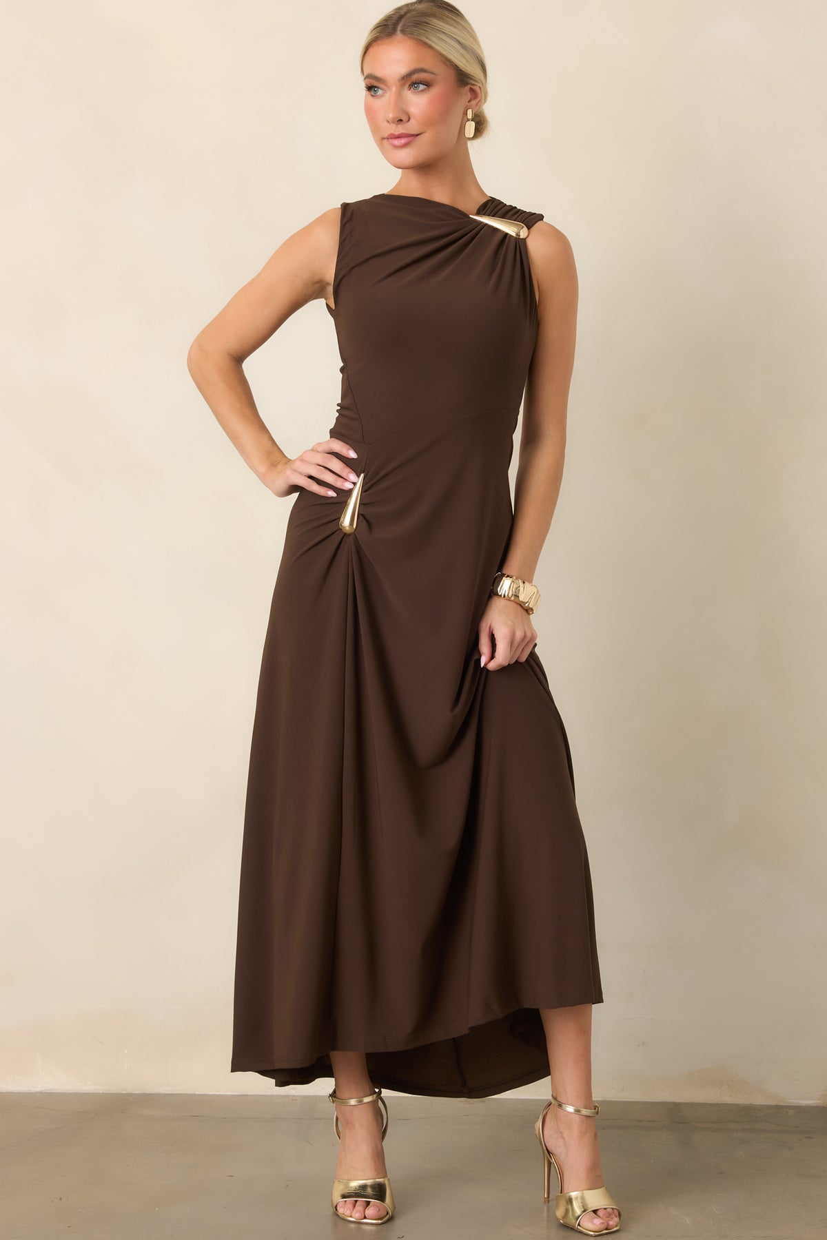 Fitted stretch dress featuring a sculptural teardrop accent, gathered hip, and asymmetrical draped neckline.