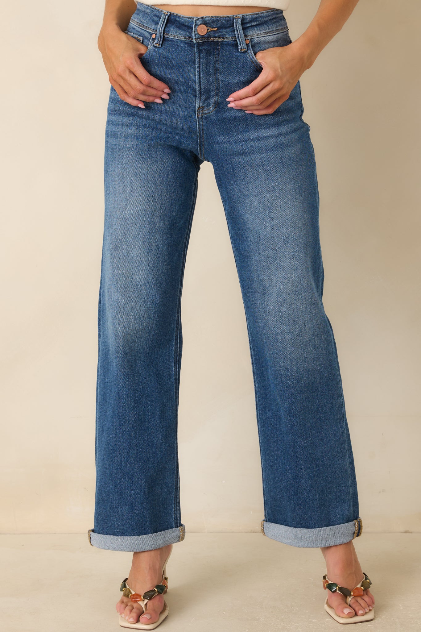 Classic five-pocket styling and subtle fading highlight the timeless design of these denim jeans.