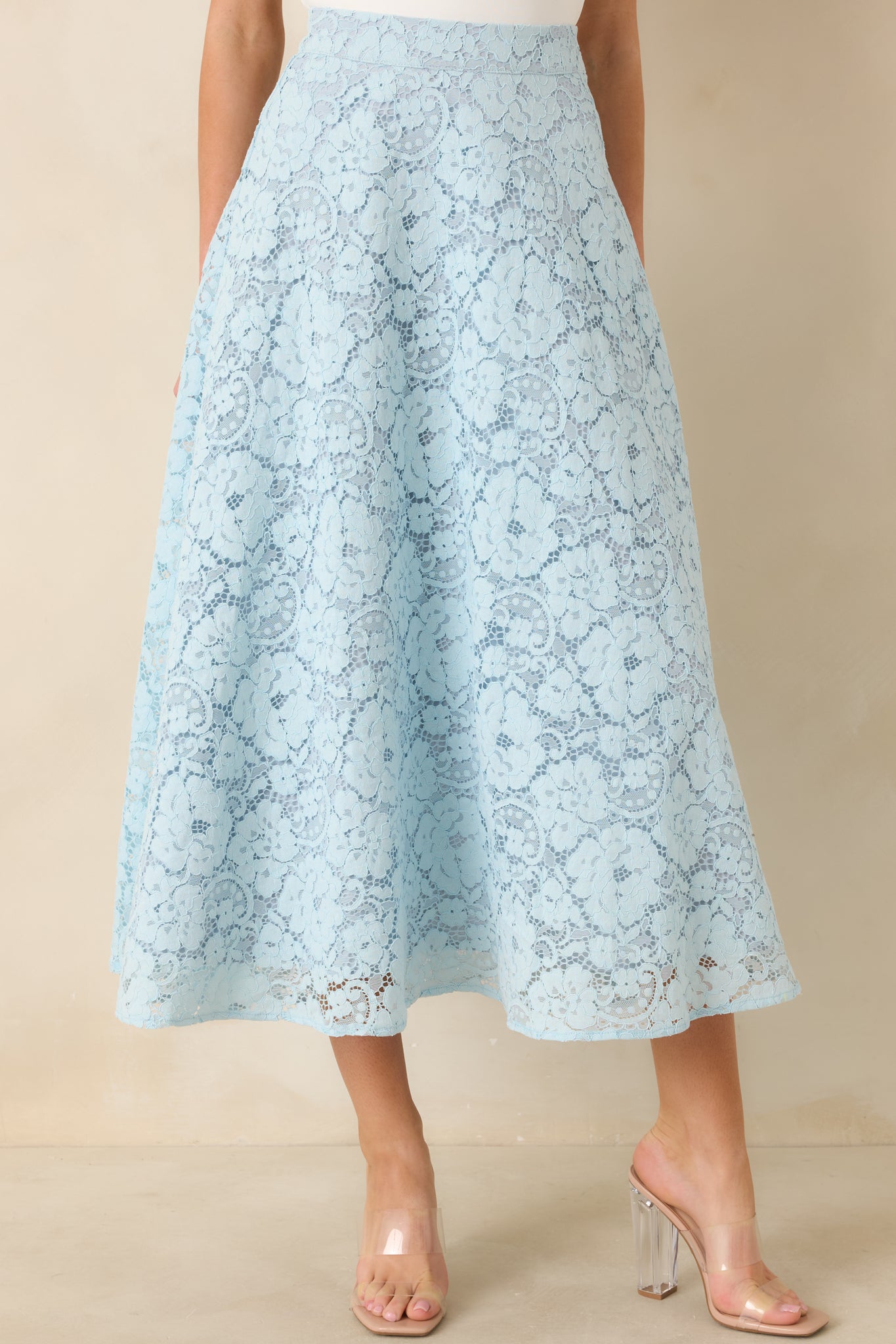 Flared hem detail showcasing scalloped lace design and soft lining beneath.