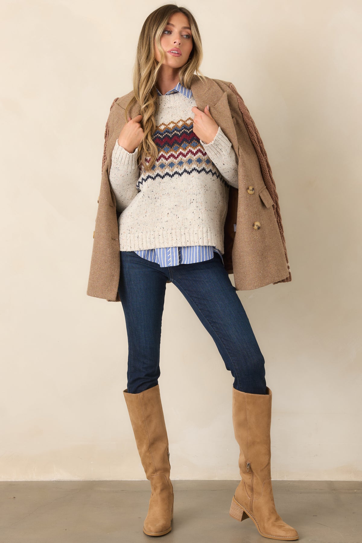 Flecked knit top in a natural hue with burgundy, navy, dusty blue, and camel bands framing the chest and sleeves.