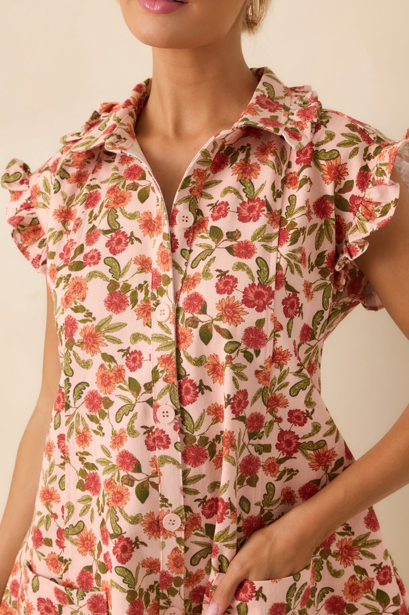 A close-up detail of the floral fabric and button front design, showcasing the texture and stitching.