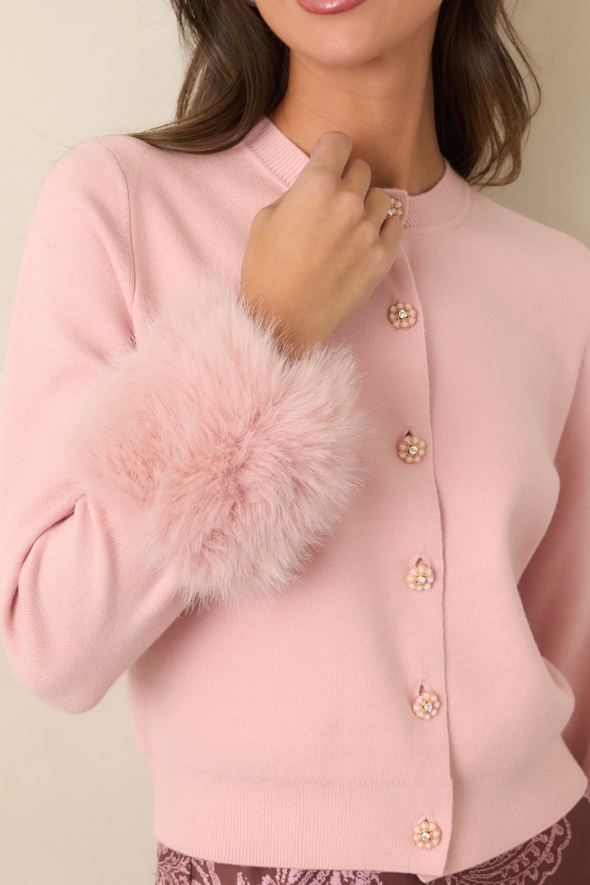 Floral cardigan buttons highlighting softly textured petals, gold-tone edging, and sparkling rhinestone centers.