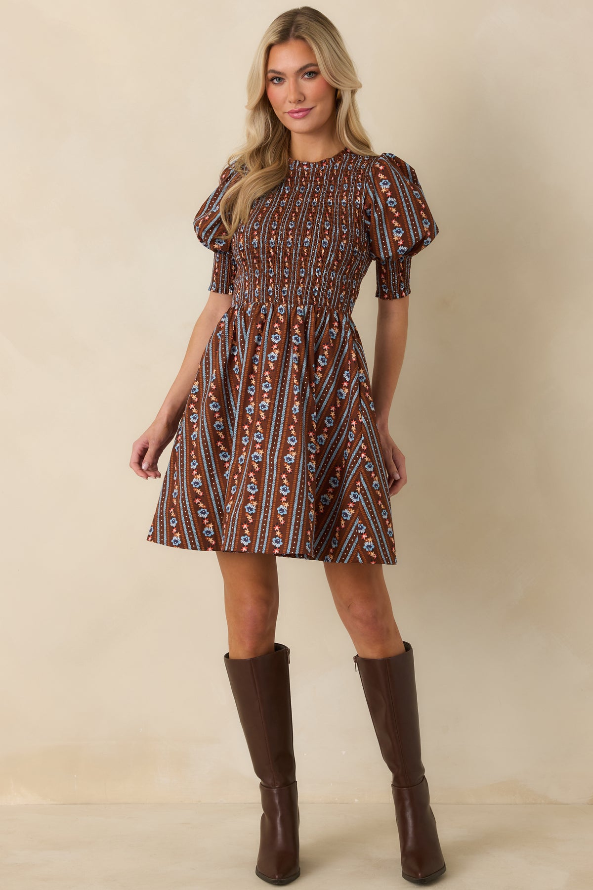 Floral cotton mini dress featuring a comfortably fitted smocked bodice, feminine puff sleeves, and a removable waist tie.