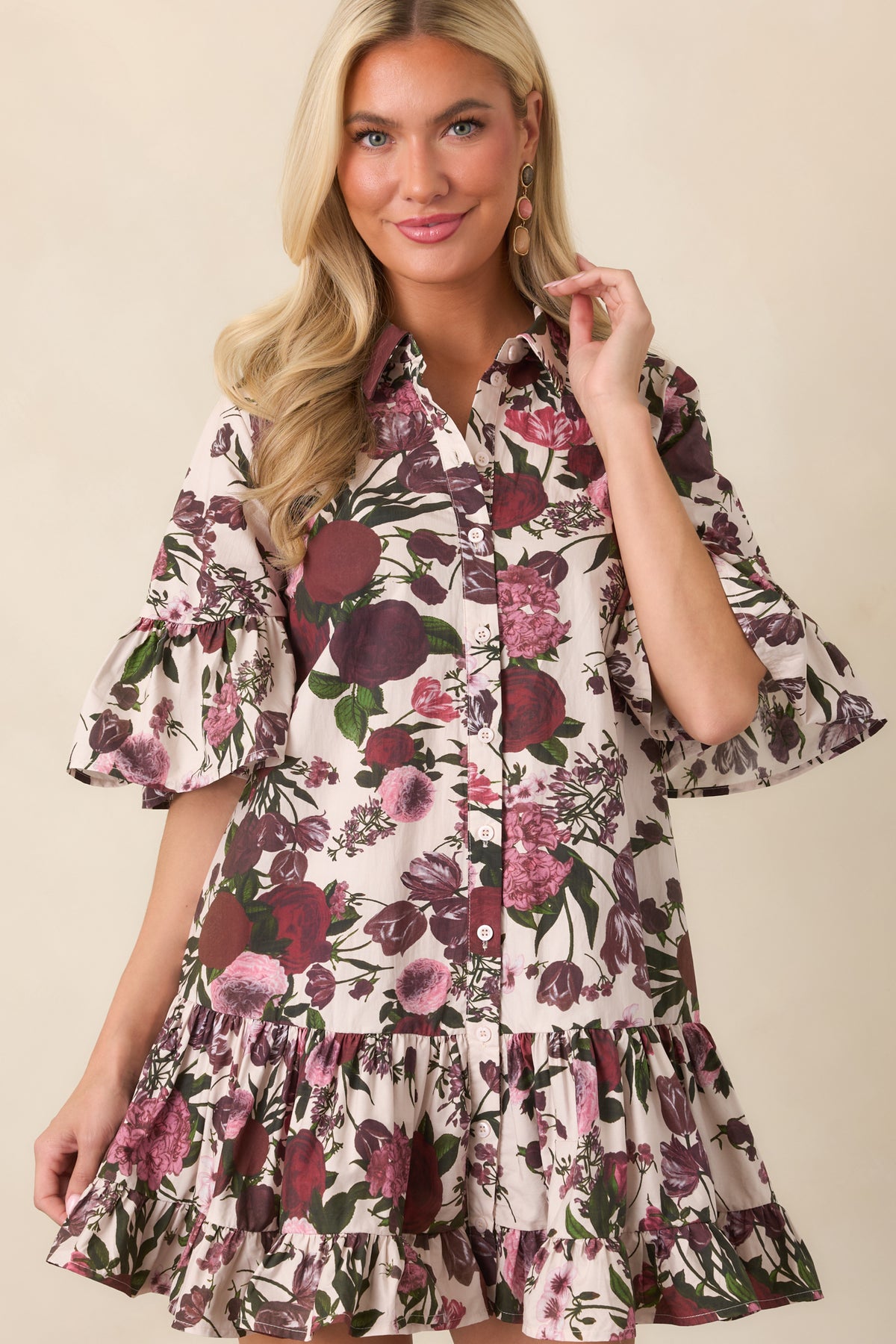 Detailed view of the cotton dress showcasing its voluminous ruffled bell sleeve and vibrant multicolor floral pattern.