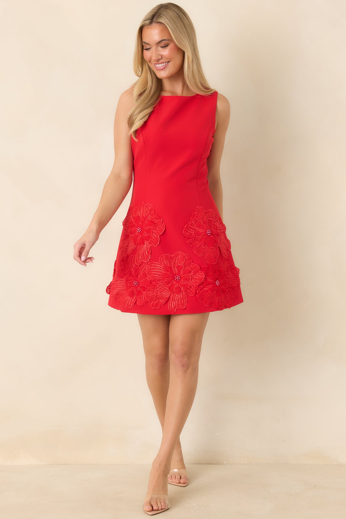 Floral embroidered mini dress with a high curved neckline, shaping seams, and a flared silhouette.