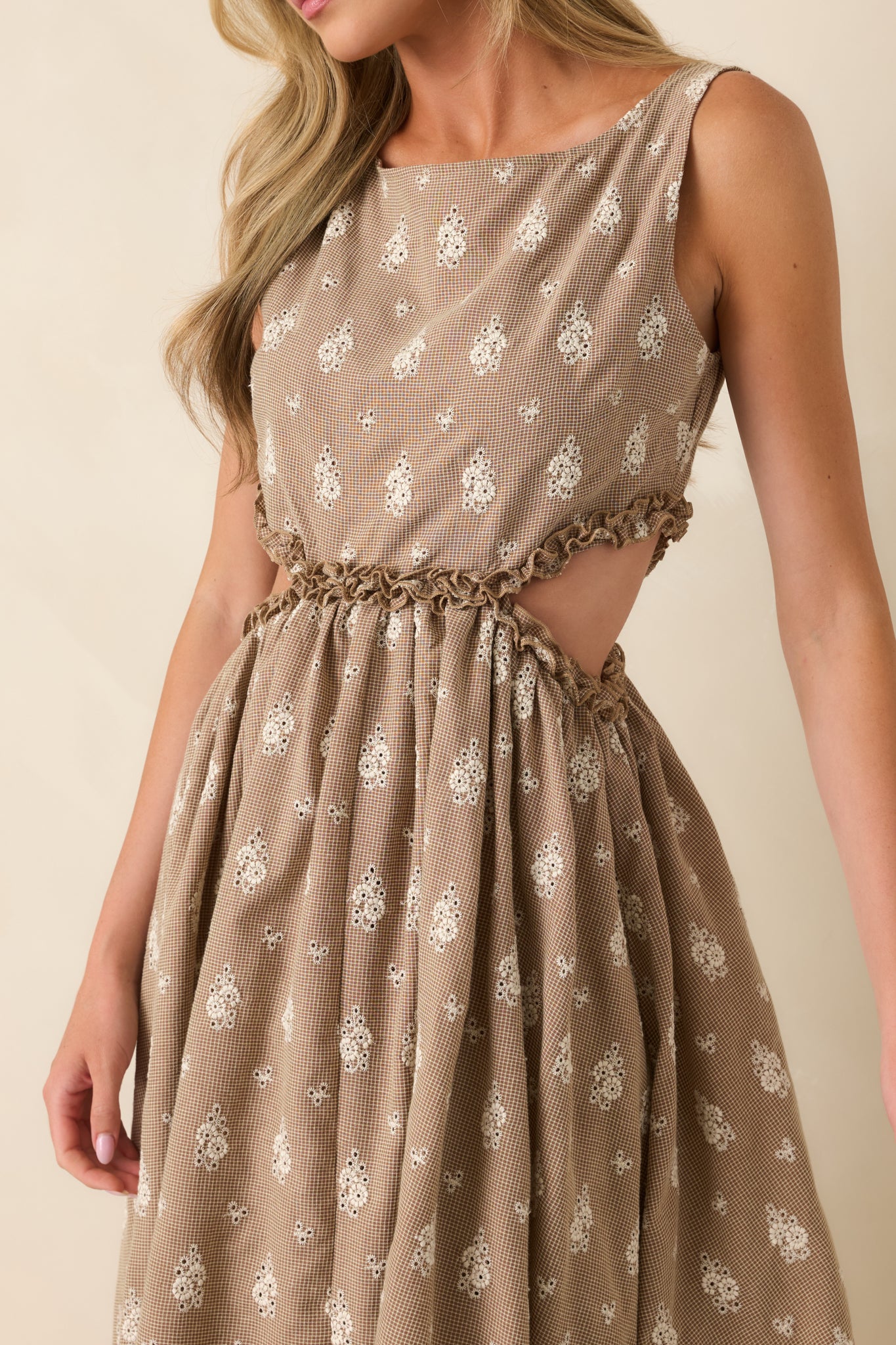 Close-up highlighting the brown and cream floral eyelet fabric, ruffle-trimmed side cut-outs, and gathered waist detailing.
