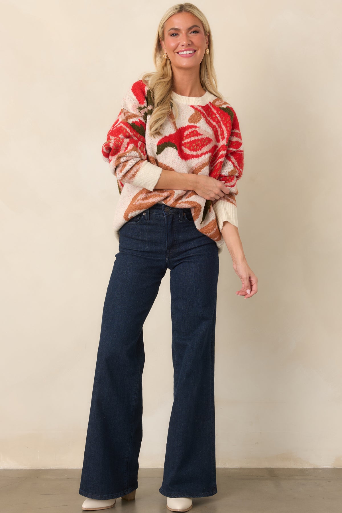 Floral fuzzy knit top with oversized red blossoms, dropped shoulders, long sleeves, and an easy relaxed shape.