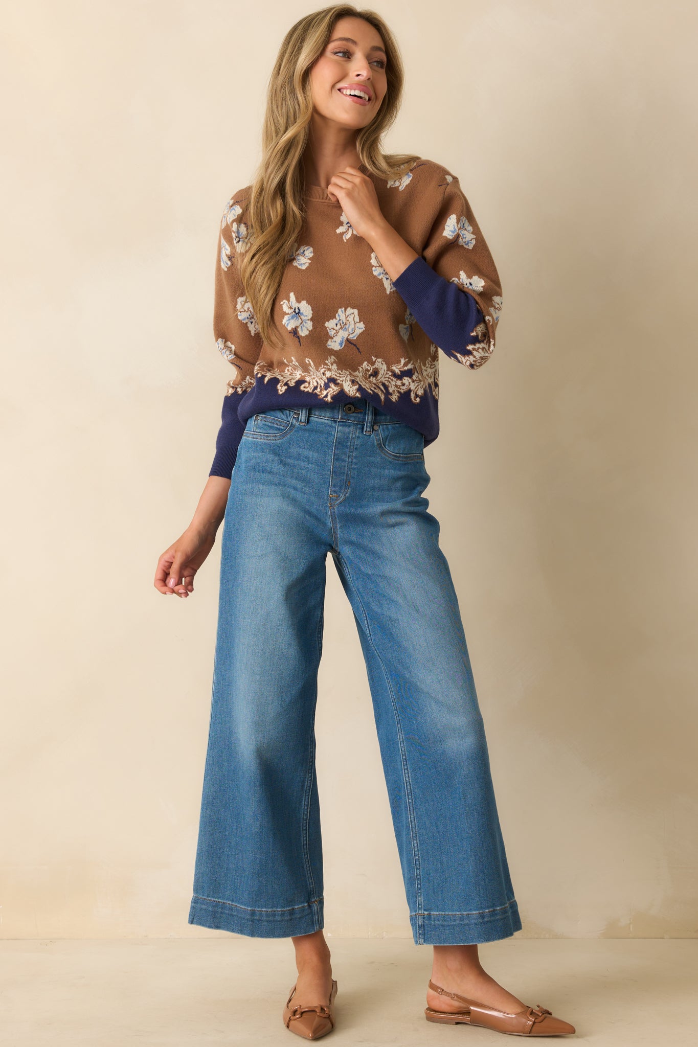 Floral knit sweater with ribbed trims and ornate border along the hem.