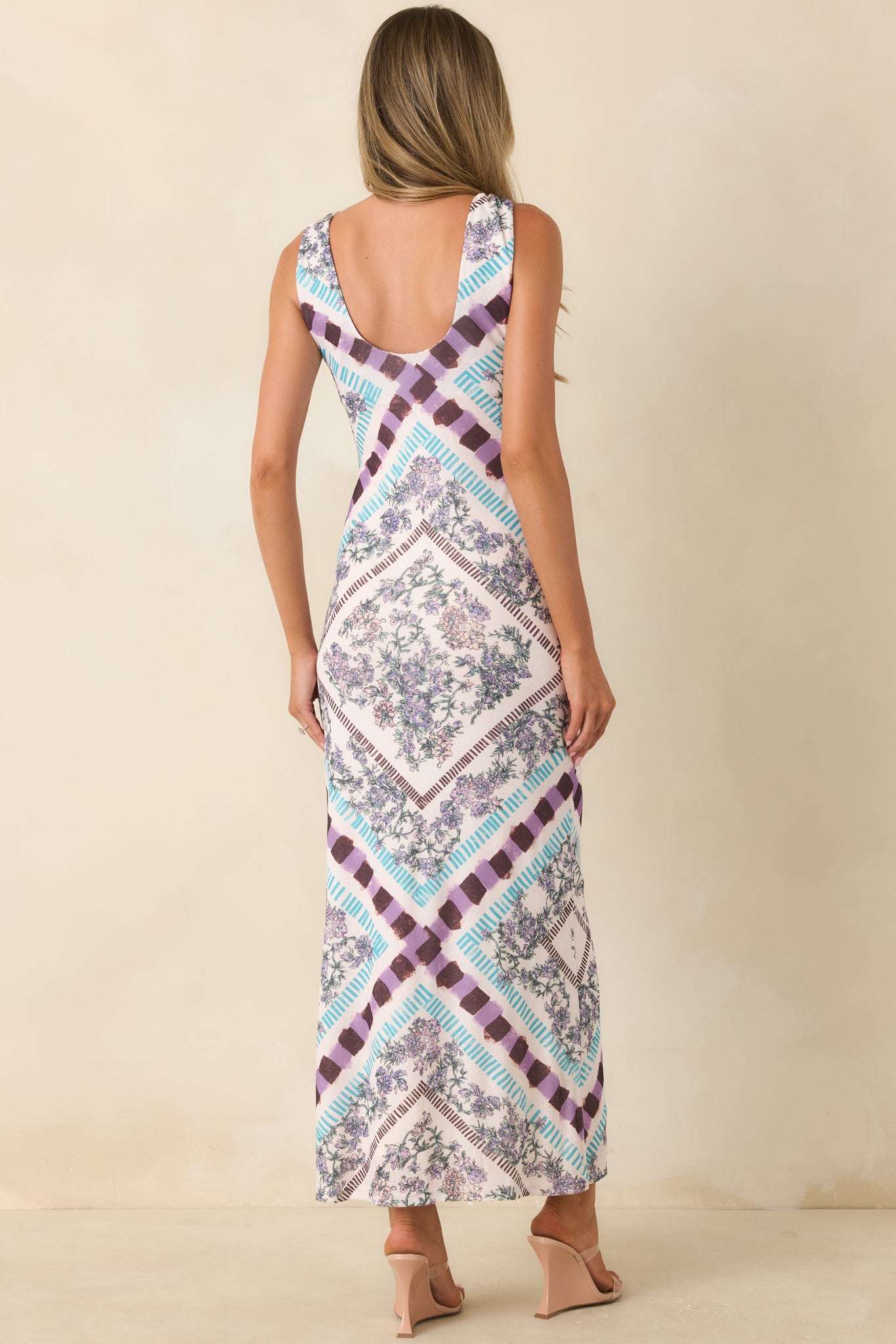 Back of the floral midi dress featuring a graceful low scoop back and sleek column silhouette.