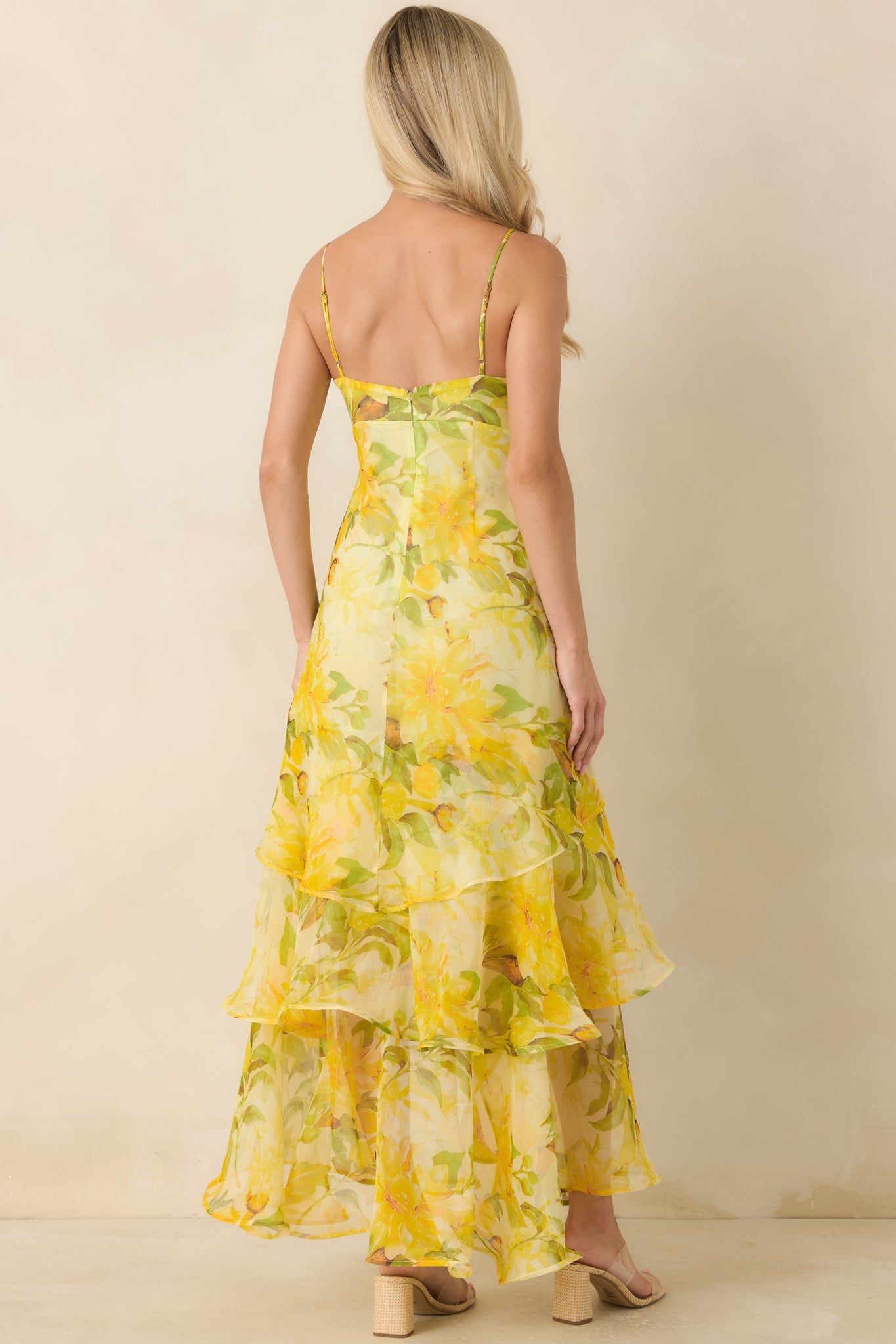 Back view of the floral maxi dress featuring adjustable spaghetti straps and a concealed zipper closure.